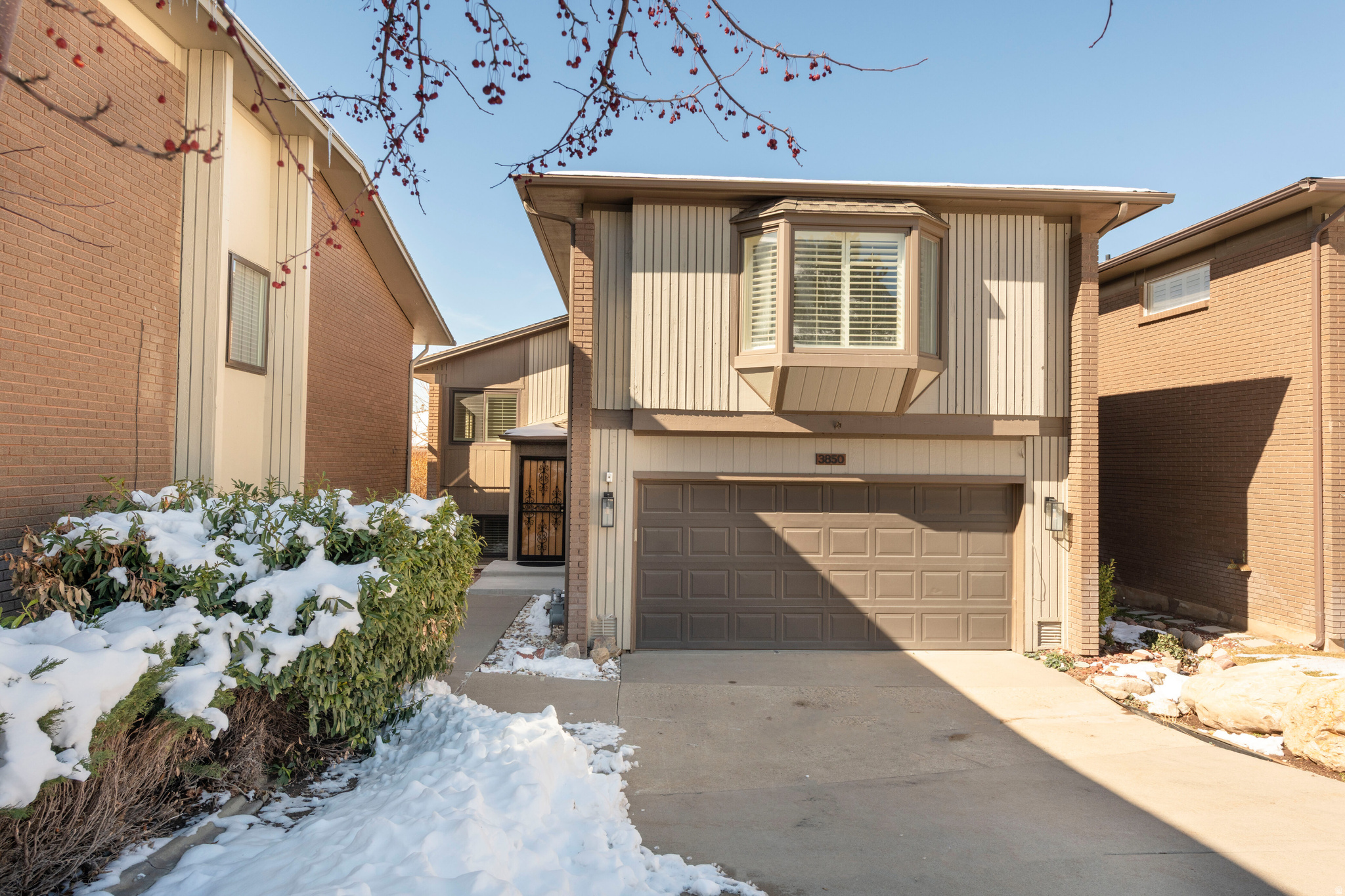 Welcome to Cove Point, a sought-after East Bench community nestled at the base of Mount Olympus and Millcreek Canyon. Enjoy a truly low-maintenance lifestyle with HOA amenities that include lawn care, snow removal, tennis and pickleball courts, and a refreshing pool for warm summer days. This home features an open and inviting floor plan highlighted by vaulted ceilings, exposed beams, and a stunning fireplace that anchors the living room. The fully renovated kitchen and bathrooms blend modern style with timeless finishes, and beautiful hardwood floors run throughout the main level. Upstairs, the spacious primary suite offers a private retreat with a large walk-in shower, dual vanities, and elegant tile flooring. The main floor includes a bedroom, a full bath, and a versatile office or den. The bright, daylight lower level provides a generous family room, an additional bedroom, and another full bath-perfect for guests or extra living space.  Meticulously maintained and thoughtfully updated, this home combines comfort, style, and convenience with easy access to shopping, dining, and the freeway.