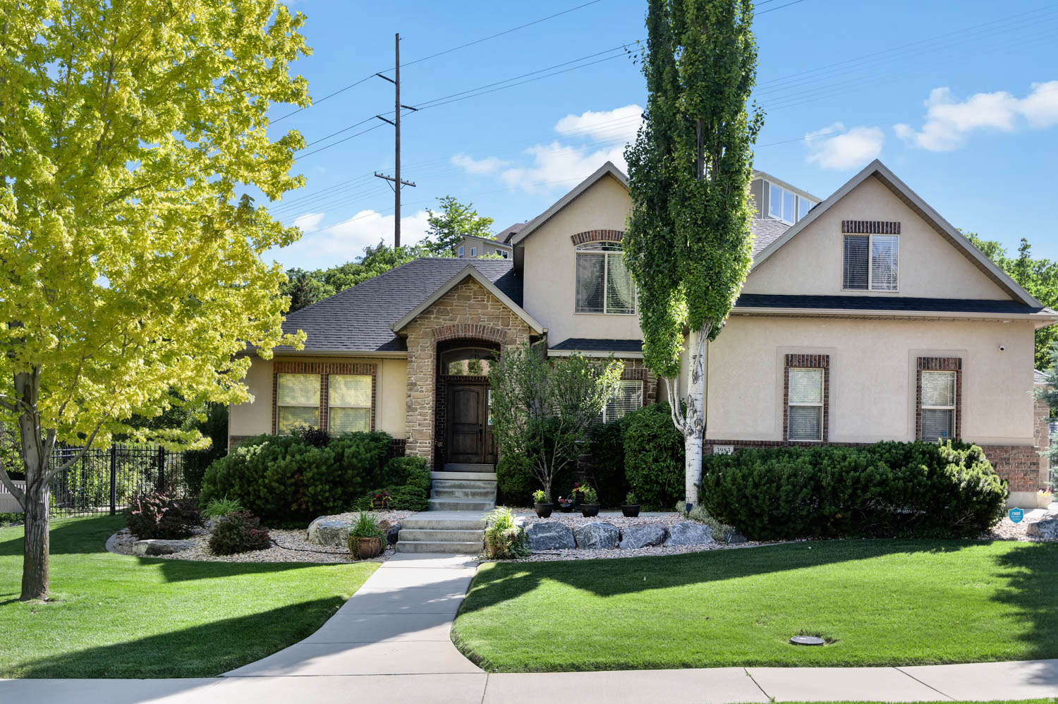 Nestled in the highly sought-after Juniper Heights neighborhood, this beautiful two-story home offers the perfect blend of comfort, space, and outdoor adventure. Just minutes from American Fork Canyon, you'll enjoy easy access to hiking, biking, fishing, and camping just minutes away. Designed with both everyday living and entertaining in mind, this spacious 7-bedroom, 3.5-bath home features a large primary suite on the main level, complete with a jetted soaking tub, dual vanities, and a generous walk-in closet. The updated kitchen showcases white cabinetry, granite countertops, hardwood floors, and a cozy double-sided fireplace that creates a warm and inviting atmosphere. Step outside to a rare, secluded backyard retreat. The fully fenced, wooded lot provides privacy and a peaceful setting that's hard to find. Additional highlights include a large 3-car garage and convenient RV parking along the side of the home. The fully finished basement offers incredible flexibility with a kitchenette, expansive family room, game room, multiple bedrooms, and ample storage-making it ideal for entertaining, guests, or multi-generational living. Located near top-rated public and private schools, this exceptional property combines a desirable location, abundant living space, and a private outdoor oasis to create the perfect place to call home. Buyer and/or buyer's agent to verify call info.