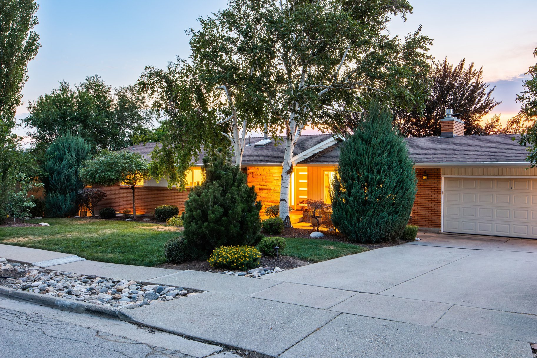 Located in the highly sought-after Olympus Cove, welcome home to 4550 Brockbank Drive. This spacious rambler-style home has beautiful updates throughout. The welcoming entry features a recently added white oak mud area with a built-in bench and cubbies. Recent renovations include new luxury vinyl plank flooring throughout the living areas, updated casing, fresh paint, top-down bottom-up blinds, and lights with remote control capability. Additional updates provide peace of mind, including a new air conditioner, replaced main water line, and water filter in 2025, and a tankless water heater and softener in 2026. The main level of this home showcases a generous living room anchored by a classic stone fireplace with gas insert, and expansive windows that fill the home with natural light. The kitchen features granite countertops, a built-in island, and opens directly to the back deck, creating an ideal space for grilling right off the kitchen. The main-level primary suite provides a peaceful retreat with a walk-in closet and an en-suite bathroom. On the lower level, the bright daylight basement expands the home's living space with a family room featuring newer built-ins and a wet bar for entertaining inside or on the expansive lower deck. The rear deck comfortably accommodates outdoor lounge and dining furniture, creating the perfect setting to relax, entertain, or enjoy a meal surrounded by the peaceful backyard setting. The beautifully landscaped yard features a serene, lush landscape, mature greenery, and a stunning beech shade tree that provides a natural gathering place during the warmer months. The grassy yard offers plenty of space for play, pets, gardening, or simply enjoying the privacy and tranquility of this exceptional Olympus Cove setting. Ideally located just minutes from Neff's and Millcreek Canyons, this home offers easy access to outdoor recreation, Olympus Cove shopping, and local dining favorites including Beaumont and Gary's. Enjoy nearby Fortuna Park with its large shaded playground, community gathering spaces, and dog meetups. Conveniently located near the amenities of downtown Holladay and Salt Lake City, with quick freeway access to Salt Lake International Airport and the world-renowned Big and Little Cottonwood Canyons for skiing, hiking, and biking. Located within a desirable school district and one of the Wasatch Front's most sought-after neighborhoods, this exceptional home offers a rare combination of comfort, convenience, and natural beauty.