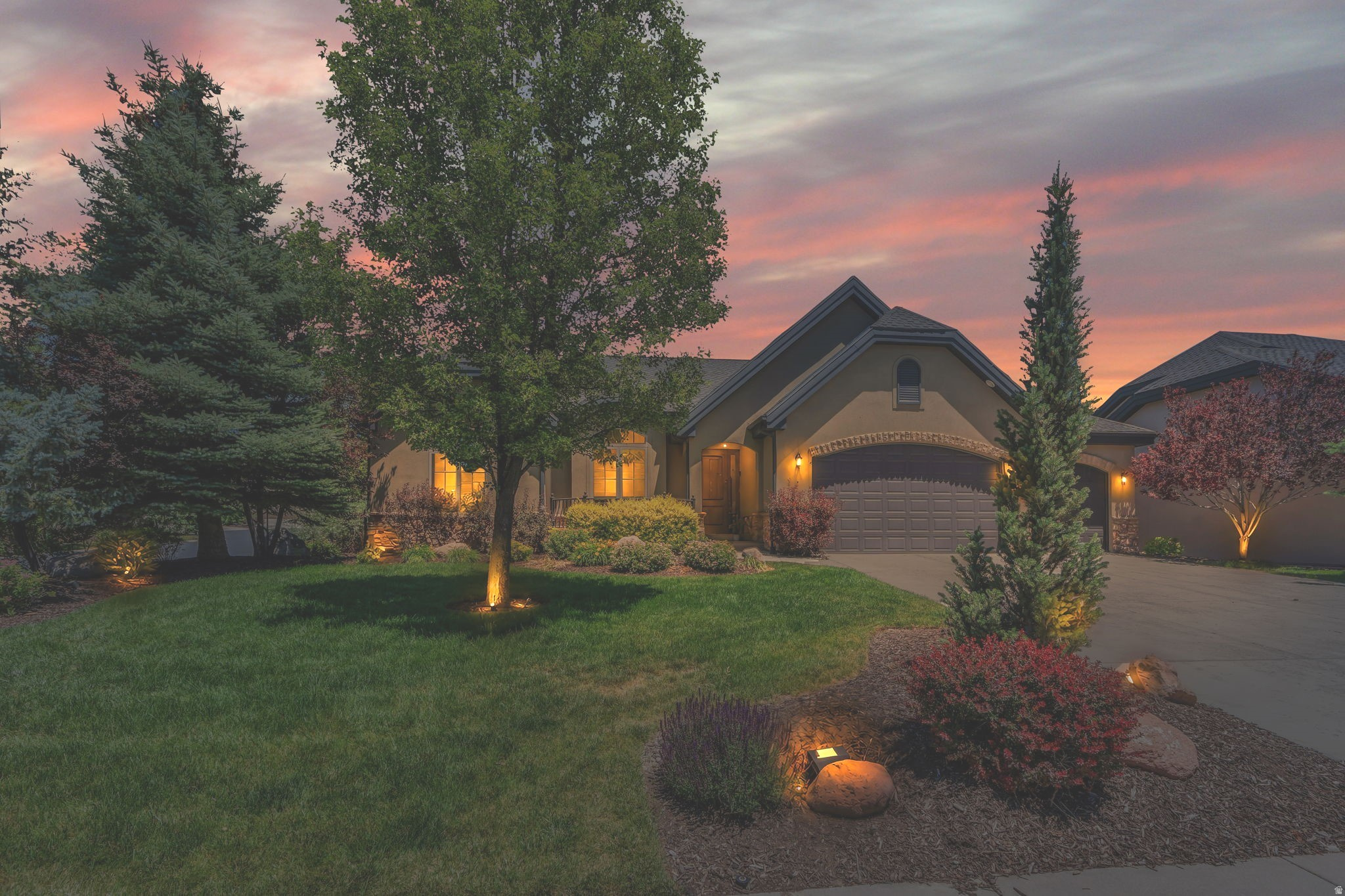 Perched atop South Mountain in Draper's prestigious Eagle Point Cottages, this exceptional luxury home offers breathtaking views, refined finishes, and a truly maintenance-free lifestyle. Surrounded by meticulously maintained landscaping and nestled in a quiet community, this residence seamlessly blends elegance, comfort, and nature.  The grand entry welcomes you with beautiful hardwood flooring that flows into the inviting family room, where a custom stone fireplace and expansive windows create a warm yet sophisticated gathering space filled with natural light.  Designed for both everyday living and entertaining, the gourmet kitchen features an oversized island with sink, granite countertops, rich floor-to-ceiling cabinetry with crown molding, a designer backsplash, built-in gas cooktop, and double wall ovens. The adjacent dining area is highlighted by a stunning chandelier and opens to a covered balcony overlooking the private backyard retreat, offering the perfect setting for outdoor dining and relaxation.  The main-level primary suite serves as a luxurious sanctuary, complete with balcony access, a charming bay window with plantation shutters, and a spa-inspired ensuite featuring dual granite vanities, a soaking tub, euro shower, and spacious walk-in closet.  The daylight walkout basement expands the home's living and entertaining possibilities with a second family room featuring a gas fireplace, an impressive theater room, and additional versatile rooms ideal for guest accommodations, a home office, fitness studio, library, or hobby space.  Step outside to your own private oasis, where a custom waterfall, mature landscaping, and 22 established trees create a serene backdrop. Whether enjoying the views from the covered balcony or relaxing on the patio below, the peaceful sounds of flowing water provide a resort-like atmosphere year-round.  Meticulously maintained and enhanced with fresh interior paint, this home offers timeless quality and exceptional comfort. Furniture may be negotiated separately.  Residents enjoy access to SunCrest's outstanding amenities, including a clubhouse, swimming pool, tennis courts, parks, picnic areas, snow removal, and miles of nearby hiking, biking, and running trails. Convenient access to Timpanogos Highway places shopping, dining, entertainment, Traverse Mountain, Cabela's, and numerous recreation opportunities just minutes away.  Experience elevated Draper living where luxury, views, and lifestyle come together in one remarkable home.