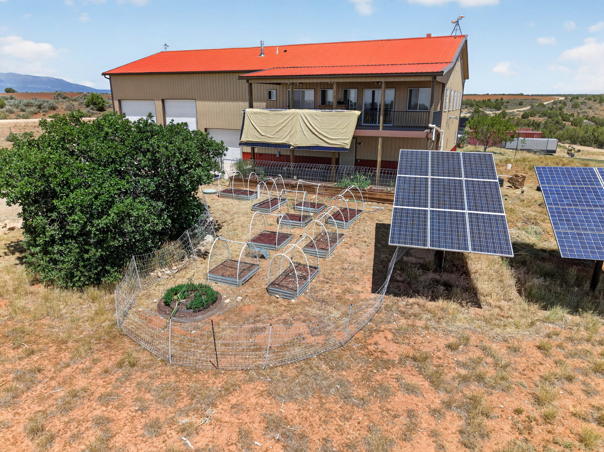 14.49 ACRES OF OFF-GRID DREAMS! Welcome to this turnkey, partially furnished 3,200 sq. ft. barndominium located south of Eastland, Utah (about a 30-minute drive from Monticello) bordering BLM land on two sides. This spacious, two-story home features three bedrooms, three bathrooms, a family room, a living room, and an eat-in kitchen complete with a breakfast bar. The living room opens beautifully to a 12' x 35' covered deck that overlooks the entire property and the adjacent BLM land. For added utility, the first floor also has an equipment room, a dedicated craft/workshop area, and a secondary kitchen featuring a stainless-steel deep sink. Engineered for complete self-sufficiency, the property's robust power system is supplied by a 4,000-watt solar system and a 3,600-watt backup system, with both 890 amp battery banks replaced in March 2023. In floor heat and hot water are reliably powered by a 1,200-watt solar electric system and a 36,000 BTU solar thermal collection system with propane backup, while two pellet stoves provide cozy, additional heat if required. The water infrastructure is equally impressive, featuring a 2,000-gallon cistern plumbed directly to the house through a whole-house water filtration system, alongside a backup 1,800-gallon cistern with a rainwater collection setup and a separate pump dedicated to garden watering. Just outside, the garden boxes are fully surrounded by an electric fence, sitting near a mini orchard of two apricot trees, two peach trees, and four apple trees. Storage and workspace on the property are unmatched, starting with the attached 1,600 sq. ft. garage. It features two high-bay stalls, each equipped with 14' high insulated doors (including one convenient pull-through bay), plus an additional bay with an 8' insulated door and a 14' x 40' enclosed mezzanine. At the rear of the house, you'll find an attached 25' x 23' shop with a 7' x 22' material storage area. Below grade, the storage continues extensively with a 5' x 43' storage area, a 5' x 21' root cellar, a 16' x 15' insulated cellar, and a 4' x 15' insulated, concealed storage area. Rounding out this incredible offering, the sale also includes a brand-new, never-erected 20' x 70' high-tunnel greenhouse, unopened security cameras, and two 40' cargo containers that come with a new, never-erected 40' fabric cover designed to span between them. The military truck used for hauling water is not included in the standard listing but can be negotiated separately.