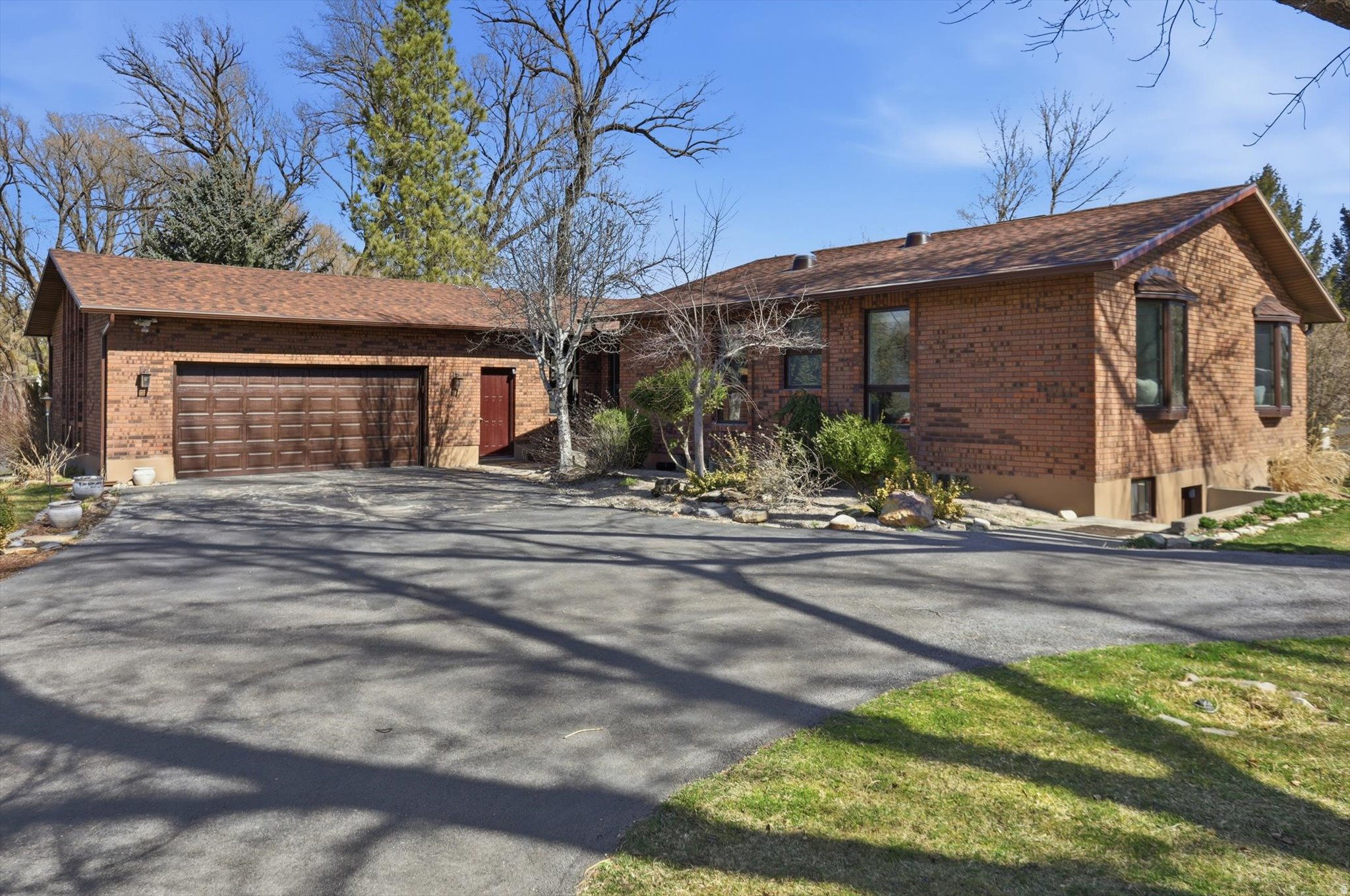 Rare Mendon property on 1.25 acres with pond setting, mature trees, and two large shops. This 3,488 sq ft rambler offers 4 bedrooms, 3 bathrooms, and a fully finished basement with separate entrance. A beautiful deck just off the dining room is surrounded by mature trees and overlooks the pond area-creating a peaceful place to relax and enjoy the property.  Recent updates include kitchen, flooring, and carpet, new roof and rain gutters. New boiler heating system and evaporative cooler.  The property includes a 30' x 60' shop and a 24' x 36' shop, providing excellent space for hobbies, equipment, storage, or workspace. Horse property with secondary irrigation water available. Zoned Commercial and Residential. *Agent related to the Seller*