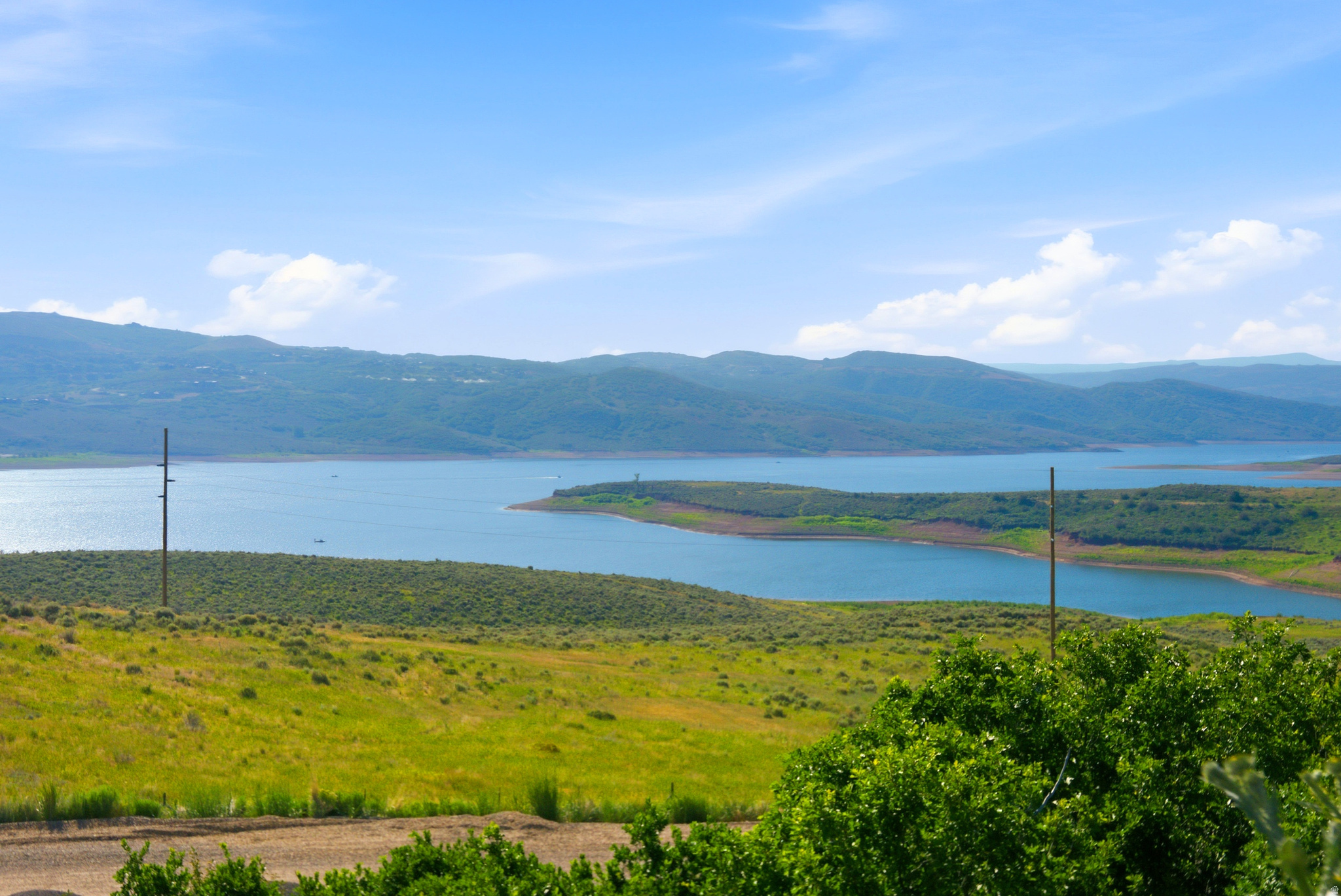 One of the few remaining undeveloped lakefront homesites in SkyRidge, this exceptional 0.19-acre property presents a rare opportunity to create your dream mountain retreat. Perfectly positioned along the shores of the Jordanelle Reservoir, this homesite showcases breathtaking, unobstructed panoramic views of both the sparkling waters of the reservoir and the iconic ski runs of Deer Valley. Designed with a downhill orientation and protected by the peace of mind that no development can be built behind it, this homesite offers a forever-preserved view corridor that is increasingly difficult to find in Park City's luxury market. Ownership within this exclusive community provides access to an unparalleled collection of amenities, including a championship golf course with a full-service pro shop, a state-of-the-art clubhouse, with pool and fitness center, a premier equestrian center featuring both indoor and outdoor arenas, and a convenient shuttle service from your home to the ski slopes.  Whether you're seeking a year-round residence or a mountain getaway, this homesite provides the ideal canvas to build a custom home that captures the very best of Utah's mountain-lake lifestyle.