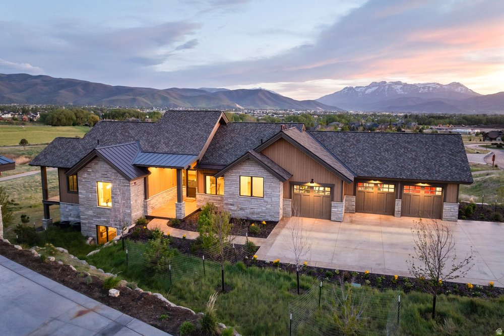 Located in the private gated community of Red Ledges, this thoughtfully designed home offers over 4,200 square feet with four en suite bedrooms, panoramic mountain and valley views, and a floor plan tailored for both comfort and entertaining. The main level provides everything needed for everyday living, including a chef's kitchen with generous prep space and walk-in pantry, open gathering areas, automated shades throughout, and heated floors in every bathroom.    The walk-out lower level offers plenty of space for family and guests with additional living and entertaining areas that open to outdoor patios and a private hot tub. Enjoy seamless indoor-outdoor living with a built-in grill on the deck, ideal for hosting or relaxing while taking in the surrounding scenery.    The oversized 3-car garage is finished with epoxy floors, built-in cabinetry, floor drains, and an EV charger. Conveniently located near the gate and Village Center amenities, this residence combines functionality, comfort, and easy access to the community's lifestyle offerings.    Lifestyle Membership available with deposit, providing access to the Village Center pool and grill, 10,000 square foot fitness center, outdoor concerts, tennis, pickleball, ski shuttles to Deer Valley East Village, and three private clubs in Deer Valley.