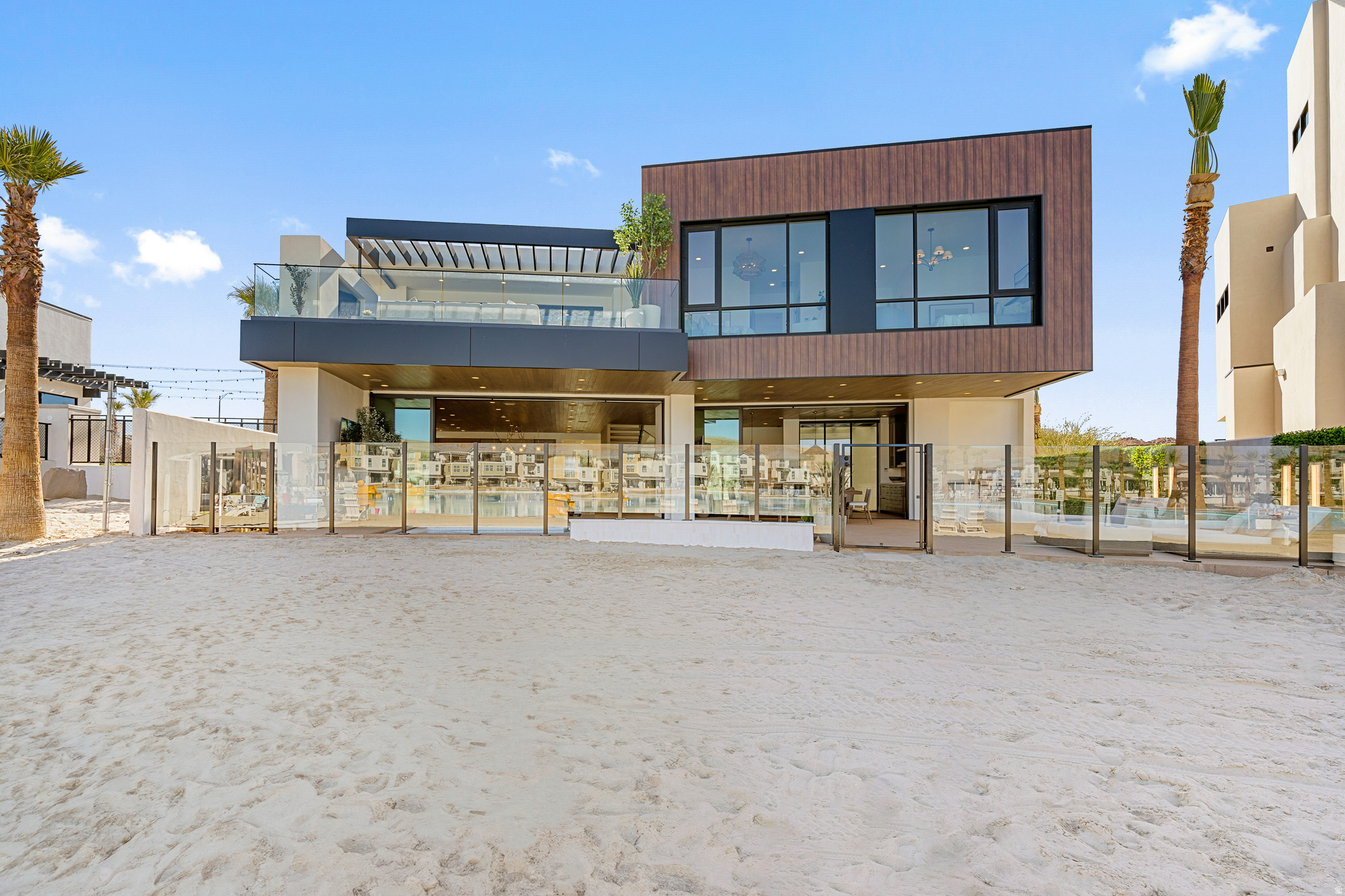 This extraordinary lagoon-front estate is one of the last opportunities to own directly on the water in Desert Color. Designed with both livability and legacy in mind, this 8-bedroom, 13-bathroom residence redefines what it means to gather well. Unlike traditional large homes where guests are isolated by floor, the thoughtful layout was intentionally crafted so every level offers space for connection allowing kids, adults, and guests to be together without sacrificing privacy or comfort. The result is a home that truly works for how people live, entertain, and unwind. Built by Split Rock Custom Homes and featuring high-end interiors by renowned designer Becki Owens, every detail feels elevated yet inviting, turning a showpiece into a home.  Zoned for nightly rentals and accommodating up to 28 guests, the property offers an unmatched resort-style experience: a private pool and hot tub, expansive game room, theatre, gym, and a dedicated wellness suite complete with cold plunge, sauna, and steam shower. Multiple indoor and outdoor gathering spaces invite memorable moments, from quiet mornings to lively evenings under the stars.  Ownership also includes access to Desert Color's premier amenities, including the iconic 2.5-acre lagoon, additional pools and hot tubs, pickleball courts, and more creating a lifestyle that blends luxury, recreation, and effortless connection.  This is more than a home. It's a destination, a retreat, and a rare lagoon-front opportunity designed to bring people together.