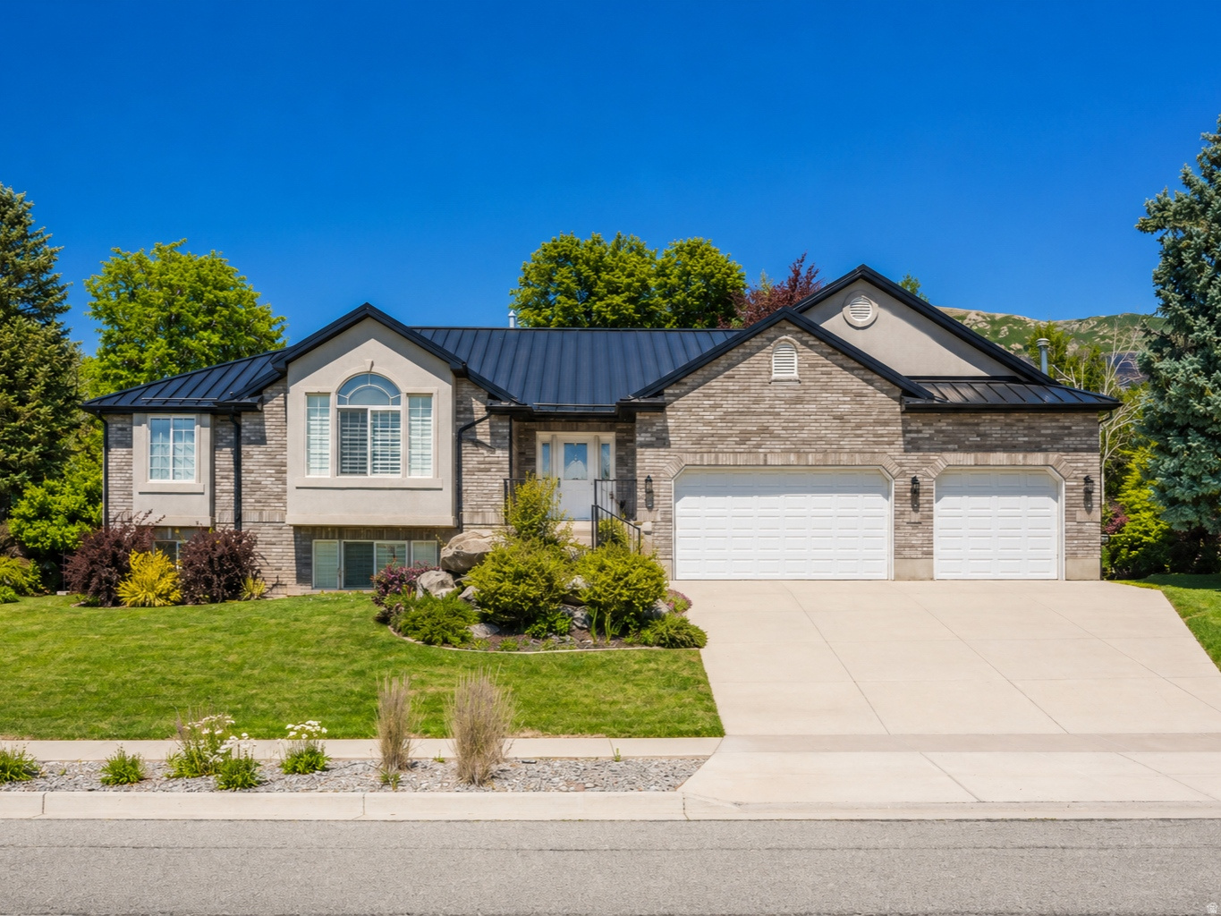 Nestled in one of Ogden's most prestigious East Bench neighborhoods, this beautifully maintained home offers the perfect blend of timeless charm, exceptional care, and an unbeatable location. Completely move-in ready, every detail reflects meticulous pride of ownership, including a new metal roof installed in 2024, hardwood floors, and elegant plantation shutters throughout.  Enjoy a private, beautifully landscaped yard with lush, mature vegetation that creates a peaceful outdoor retreat. The walkout basement offers excellent potential for an accessory dwelling unit (ADU), making it ideal for multigenerational living, guests, or future rental income.  Conveniently located within walking distance of a highly rated elementary school and just five minutes from Weber State University, this home combines the tranquility of a premier neighborhood with easy access to schools, recreation, shopping, and dining. Opportunities like this are rare-don't miss your chance to own a truly home.