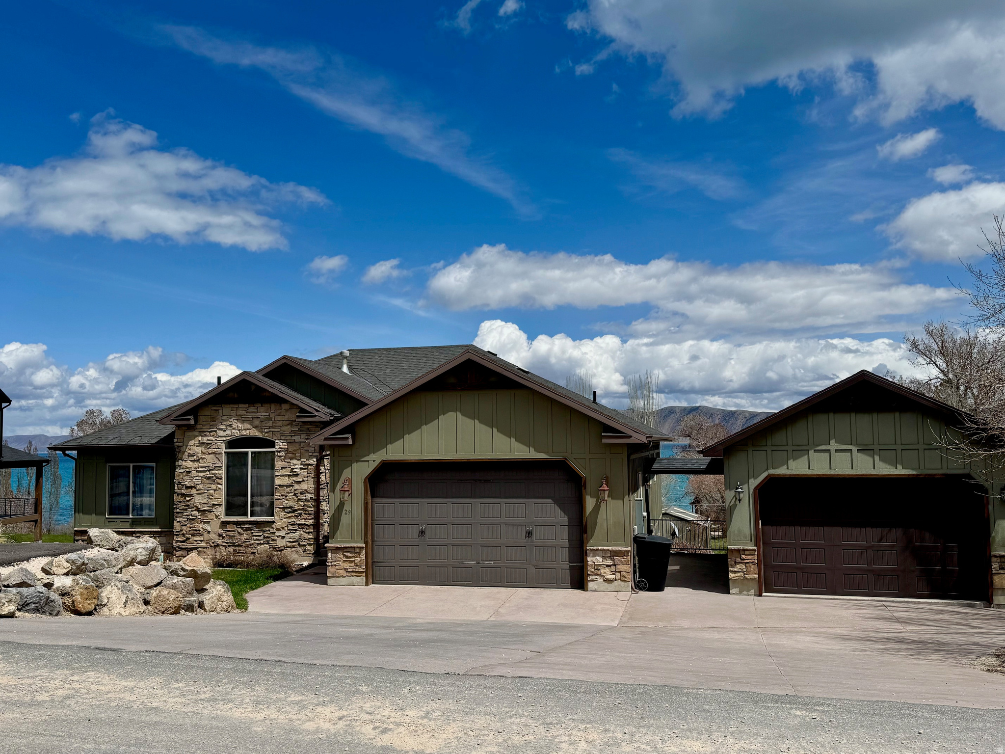 Gorgeous Bear Lake VIEW without being high on the hill, this beautiful, extremely well-kept home (never been in rental pool), has a detached additional garage for your toys or extra vehicle AND an attractive office/mancave with lake view! Paved road off Hodges Canyon Road with easy access to forest for ATV/Snowmobiling enjoyment. Public lake access, Golf Course, Pickleville Playhouse close. Marina 2 miles, Beaver Mountain Ski 30 minutes. Bike/walking path all the way to Garden City and beyond!  Large .56-acre lot with propane BBQ pit in the yard, and potential to landscape further with room for Pickleball Court, Gazebo, play area etc. Parking area for your boat or extra vehicles.