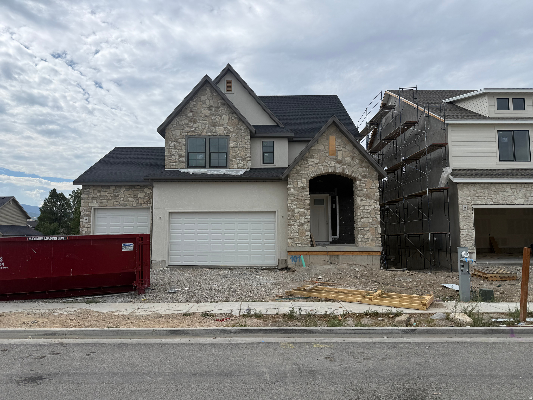 LOT#101. Symphony Homes Summerhill Lane. Come see this 'Rose' floorplan in this growing new community! This is a spacious 2-story with a true 3-car garage, a European Romantic exterior with stone, lots of upgrades throughout, and tasteful interior design and finishes! Galley kitchen, walk-in butler's pantry with countertop and outlets, 6-burner 36" gas range, and spacious dining nook. Family room features a fireplace and large windows for plenty of natural light. Entry is open to upper level loft. Large Primary suite has a tray ceiling with crown molding and bathroom features a dual vanity, oversized garden tub, separate shower, and a large walk-in closet. An additional two bedrooms upstairs, laundry room, and loft area open to entry below with space to put a desk. Finished basement with large family/game room, 1 large bedroom with a walk-in closet and a full bathroom! 12x24 covered deck, upgraded insulation, LVP flooring, lots of storage space throughout. Secondary water stubbed to lot, and equipped with active radon system.