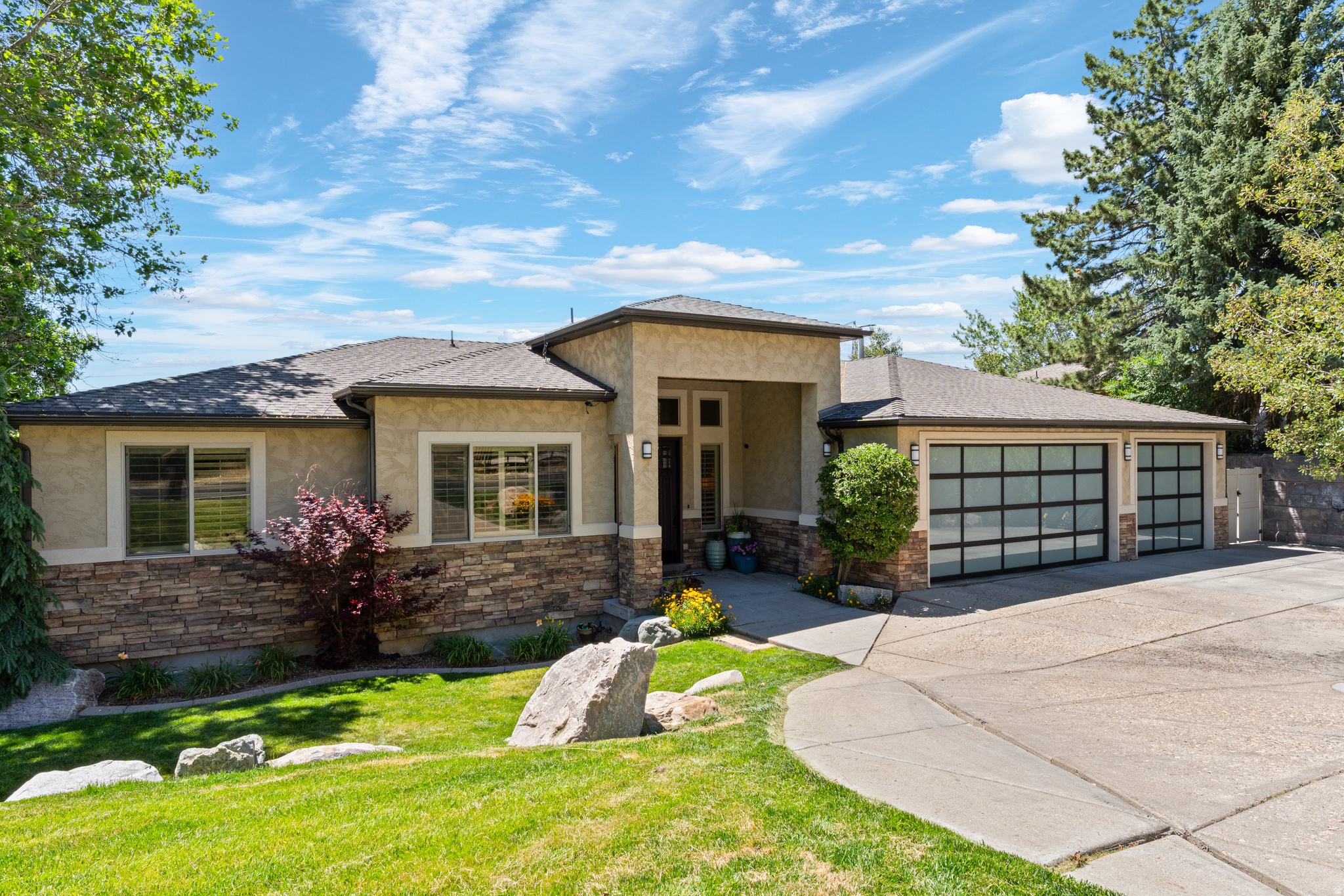 **OPEN HOUSE Saturday, 6/20, 10 AM - 1 PM** A home like this is hard to find!!Located high on the East Bench in Fruit Heights, this custom home captures breathtaking valley and foothill views while offering unmatched privacy directly across from Forest Service land, with immediate access to hiking and biking trails. Designed for both luxury and recreation, the home features 5 bedrooms, multiple gathering spaces, and a rare indoor basketball court. Enjoy the convenience of main-level living, highlighted by a spacious owner's suite with private access to the covered deck and stunning views. The main floor also features a dedicated office/library, laundry room, and an open-concept great room with a fireplace and expansive picture windows that perfectly frame the surrounding landscape. Two additional access points to the covered deck create seamless indoor-outdoor living and make the most of the home's incredible setting. The expansive, fully finished lower level boasts impressive 14-foot ceilings, creating a bright and open atmosphere throughout. Complete with a full kitchen, this versatile space is ideal for entertaining, multi-generational living, or use as a basement apartment. Step outside to enjoy the large covered deck overlooking the valley, or gather with family and friends on the covered patio featuring a cozy fire pit. Situated on a generous .36-acre lot, the property offers endless possibilities, with ample space for a future pool, sports court, or additional outdoor amenities. Conveniently located just 5 minutes from Station Park, 20 minutes from Salt Lake City International Airport, 25 minutes from Snowbasin Resort, and 30 minutes from Pineview Reservoir, the home also offers quick freeway access for convenient travel north or south. This exceptional property combines stunning views, privacy, luxury, recreation, and convenience in one remarkable East Bench setting. All offers will be reviewed on Monday by 5 PM.