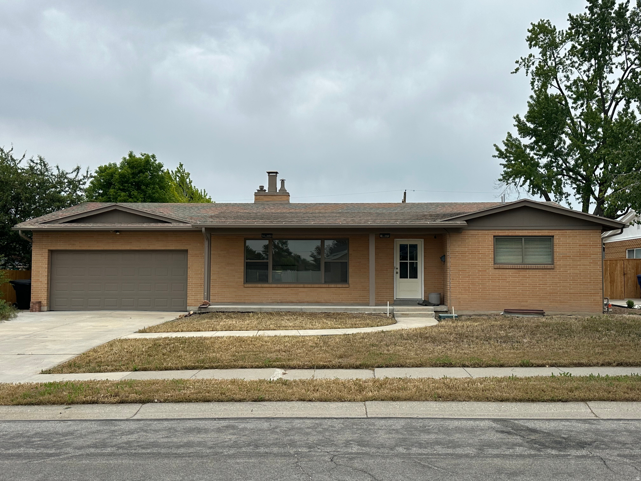 East-side ranch/rambler with mountain views in one of Salt Lake's most desirable neighborhoods. This 4-bedroom, 3-bath home offers approximately 2800 sq. ft. of living space on a spacious .25-acre lot with a versatile layout and tremendous upside.  Main level features hardwood floors, abundant natural light, and a pass-through fireplace that creates warmth  throughout the living space. The updated lower level includes a remodeled basement, new bathroom, new laundry area, fireplace insert, and separate entrance - ideal for guests, multigenerational living, rental potential, home office space, or additional entertaining.  The large backyard offers a blank canvas for outdoor living, landscaping, gardening, or future customization. Oversized two-car garage and generous storage throughout.  Conveniently located near parks, shopping, dining, and freeway access.Rare opportunity to own a well-maintained home with character, flexibility, views, and value in an established east-side location.