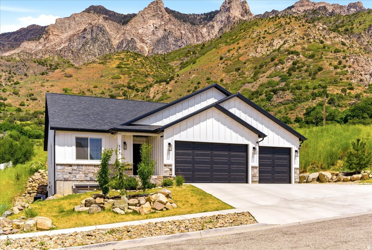 Nestled against the stunning mountains, this better-than-new fully finished home offers the perfect blend of luxury, functionality, and breathtaking scenery. Built just 2 years ago, this 5-bedroom, 3.5-bath home gives you the benefits of new construction without the wait or added expense of finishing a basement and landscaping. Inside, you'll find spacious open living areas with room for everyone, including an additional basement family room complete with a stylish wet bar-perfect for entertaining, movie nights, or hosting guests. The thoughtfully designed floor plan provides comfort and flexibility for both everyday living and gatherings. Car enthusiasts and hobbyists will love the oversized 4-car garage featuring an electric vehicle charger and a convenient half bath-ideal for anyone who enjoys spending time working in the garage without tracking through the house. Step outside and enjoy incredible mountain views right from your backyard, while the front yard offers sweeping views toward the Great Salt Lake. Located just minutes from Willard Bay State Park, you'll have quick access to the beach, boating, fishing, and outdoor recreation. Nearby hiking trails and beautiful waterfalls make this home a dream location for outdoor lovers. Schedule a showing to check it out today! Buyer to verify all information given.