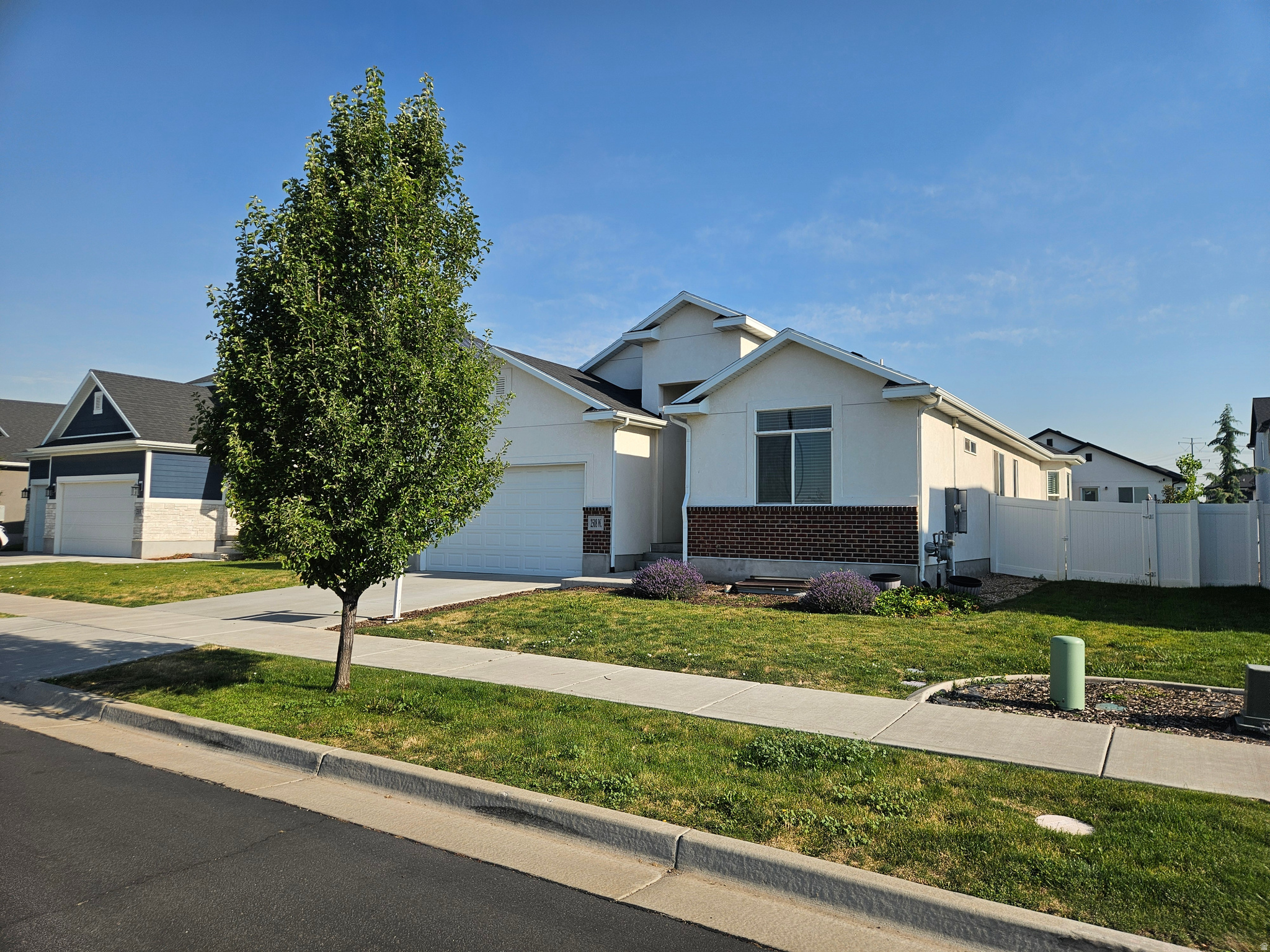 Must-see home across the street from Harmony Park. This beautiful home features 5 bedrooms, 2 baths and an open living concept with vaulted ceilings.  Gorgeous kitchen with huge bar.  Head downstairs to the basement where you'll find 2 large bedrooms and space for a huge living room and another bedroom.  Laundry is conveniently located on the main level, and the home also offers fiber internet availability and generous storage throughout. Step outside and enjoy the fully fenced, low maintenance yard designed for relaxing without the upkeep. The patio is perfect for BBQs, and there are pickleball courts across the street. The HOA provides common area landscaping, snow removal, and front lawn mowing. Situated in a prime Layton location with rapid access to the West Davis Corridor, this home offers a seamless commute while still enjoying the peace of a quiet residential neighborhood. You'll love being just a short walk from the local elementary school. Solar panels are owned and will transfer with sale.