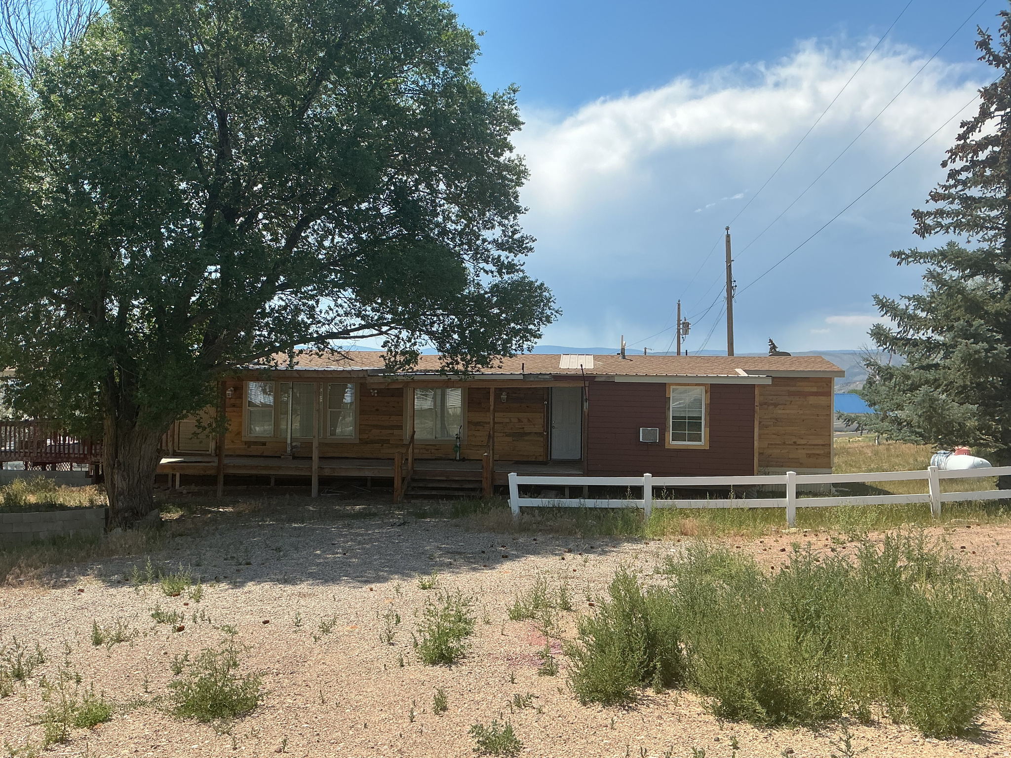 Wonderful property with large wraparound deck and .33 lot/yard.  House needs TLC but substantially aesthetic.  CASH ONLY.  Unfinancable: older mobile.    Square footage figures are provided as a courtesy estimate only and were obtained from county.  Buyer is advised to obtain an independent measurement.