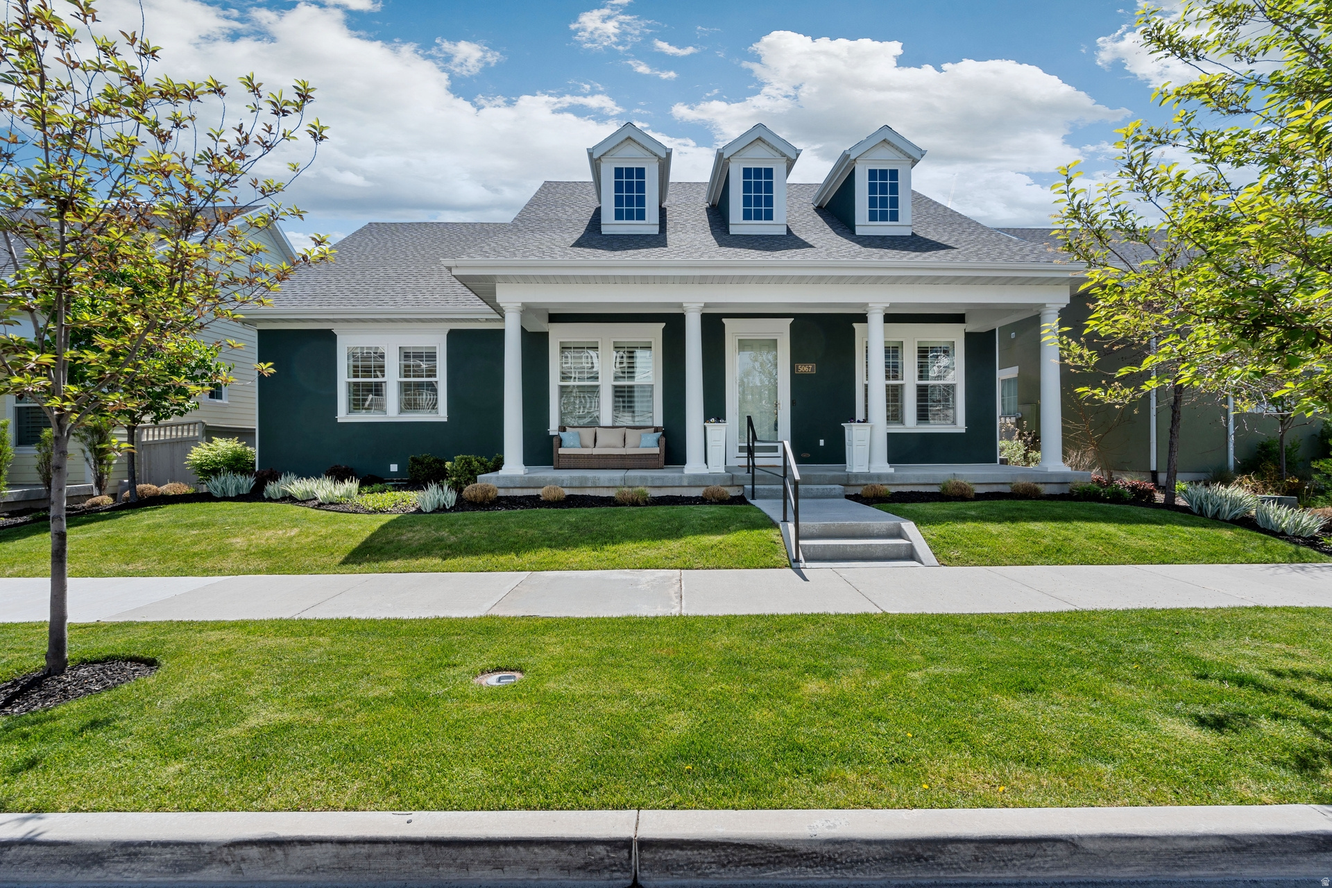 Perfectly positioned in a prime location within Daybreak, this Energy Star Certified rambler in South Jordan offers over 4,100 sq ft of beautifully updated living space with soaring ceilings, fresh paint, and new flooring throughout. The designer kitchen shines with an oversized island, high-end appliances, and a walk-in pantry-perfect for both everyday living and entertaining.  Enjoy seamless indoor-outdoor living with two covered porches, a fully fenced yard, and a quiet, tree-lined street. The luxurious main-level primary suite features a spa-like bath and a generous walk-in closet. Downstairs, the finished basement offers a second family room, guest suite, and additional space ready for your personal touch.  The garage has been thoughtfully configured for ADA accessibility with a lift installed; traditional stairs are also available and can be easily reinstalled if desired.  Located just steps from Soda Row, The Island, Harmons, and the new Bees Baseball Stadium, this home delivers elevated living in one of South Jordan's most vibrant and sought-after Daybreak communities.