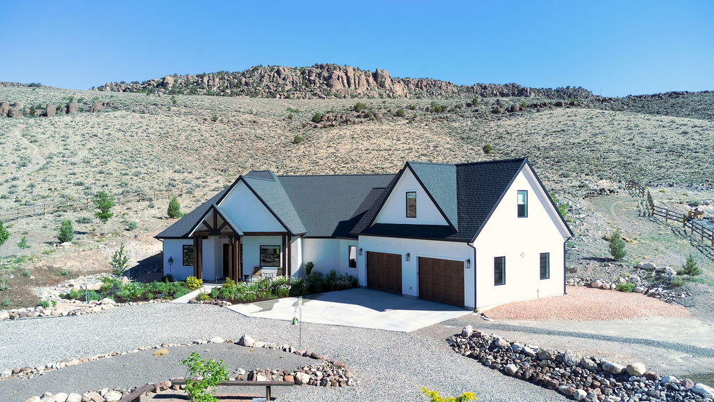 One-Owner Custom Estate on 6.07 Acres | Backs to BLM | Casita, 2,000 SF Shop, Orchard, RV Hookups & Panoramic Mountain Views  Offered for the first time, this exceptional one-owner custom estate is a rare opportunity to own a property where quality, craftsmanship, and thoughtful design are evident throughout. Built as the owners' forever home, every detail reflects pride of ownership, careful planning, and a commitment to lasting quality. Situated on 6.07 private acres backing directly to BLM land, the property offers an extraordinary combination of privacy, functionality, self-sufficiency, and breathtaking mountain views.  Surrounded by more than 100 trees, established shrubs, a producing orchard, and beautifully maintained landscaping, the grounds create a private park-like setting rarely found in the area. A natural artesian well and fully automated drip irrigation system service the property's extensive trees, shrubs, orchard, greenhouse, and landscape beds, helping maintain the beauty of the grounds with remarkable efficiency. Despite the mature landscaping and abundant vegetation, water costs average approximately $40.00 per month.  The custom-built residence features 3 bedrooms, 2.5 bathrooms, a dedicated office, a spacious bonus room, an attached two-car garage, and a covered patio overlooking the picturesque north hillside. The patio provides the perfect setting for outdoor dining, entertaining, or simply enjoying the peaceful surroundings and panoramic views of Thousand Lake Mountain, Boulder Mountain, and Parker Mountain.  Inside, the home showcases maple hardwood flooring, Pella wood windows, soaring 10-foot ceilings, vaulted living spaces, oversized 8-foot doors, custom solid-wood cabinetry, quartz countertops, double convection ovens, radiant heated floors, central vacuum, and a stunning 60-inch fireplace that anchors the main living area.  The thoughtfully designed floor plan offers both functionality and elegance, featuring a large walk-in pantry, generous storage, double vanities, and a spacious primary suite designed as a private retreat. The guest bedrooms are connected by a beautifully designed Jack-and-Jill bathroom, providing comfort and privacy for family and guests alike.  Designed for year-round comfort and efficiency, the home features radiant floor heat powered by both propane and electric boiler systems, high-efficiency central air conditioning, fiber-optic internet, Orbi whole-home WiFi, two radon mitigation systems, and an updated artesian well system. High-speed fiber connectivity provides the convenience needed for remote work, streaming, and modern living while still enjoying the privacy of a rural estate.  The property also includes a charming one-bedroom casita complete with granite countertops and its own attached garage. Ideal for guests, extended family, a private office, caretaker quarters, or potential rental income, the casita offers exceptional flexibility while maintaining the same quality standards found throughout the property.  A standout feature of the estate is the impressive 40' x 50' detached shop offering  2,000 square feet of additional space. Equipped with 220 power and finished with a professional-grade epoxy resin floor, the shop is ideal for vehicles, recreational equipment, storage, hobbies, projects, or workshop use.  Additional improvements include a greenhouse equipped with its own automated drip irrigation system, extensive parking, and a dedicated RV pad with full operational hookups, including water, sewer, and power. Whether accommodating visiting family and friends or extended RV stays, the setup is ready for immediate use.  The mature producing orchard features cherry, peach, apple, plum, and pear trees, providing seasonal harvests while enhancing the property's self-sufficient appeal. Snow-break systems on both the shop and casita, along with heat tape in the rain gutters, further demonstrate the level of care, planning, and investment that has gone into this r