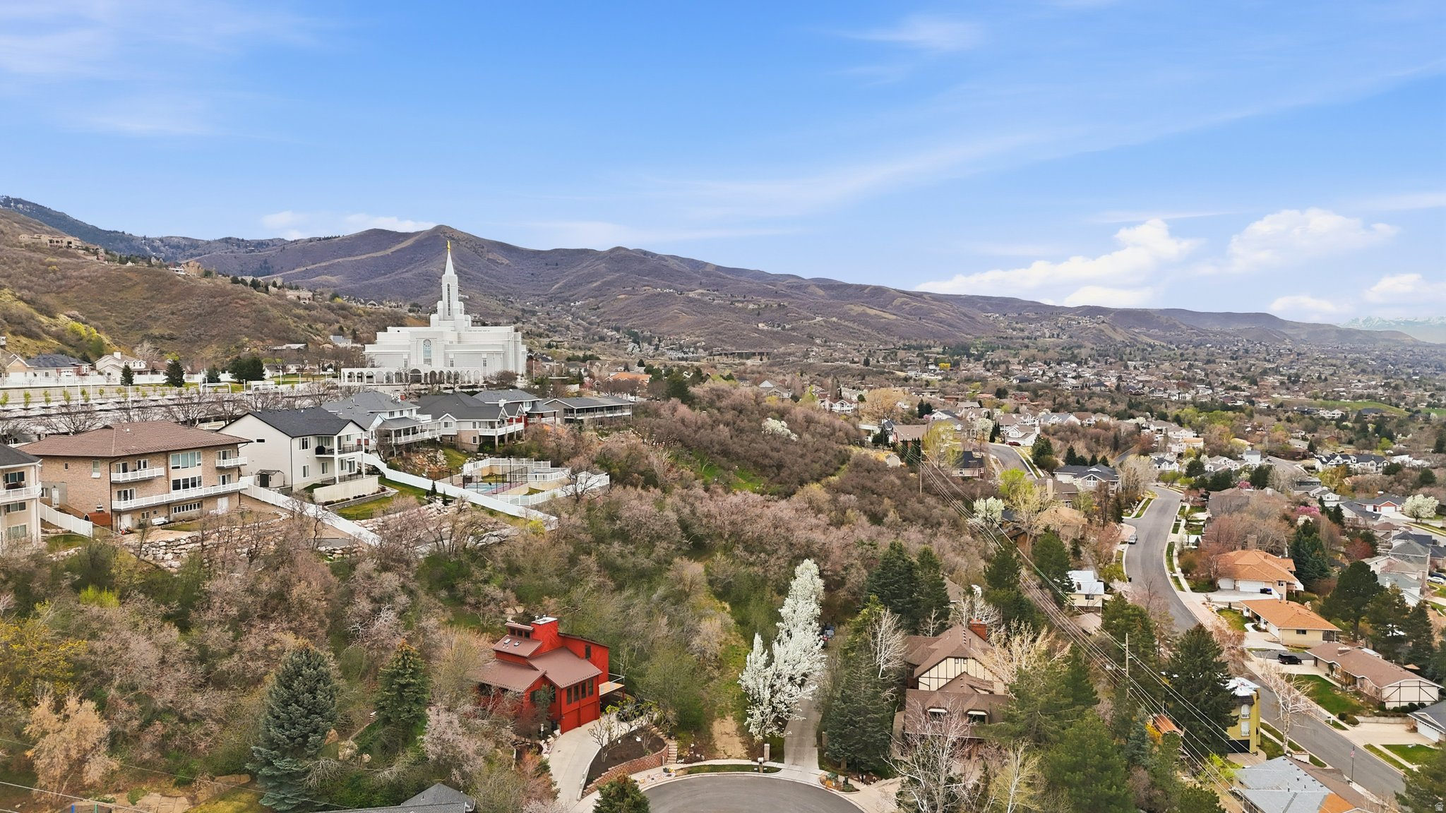 Premium east bench opportunity in Bountiful! Nestled at the end of a quiet cul-de-sac, this rare west-facing flag lot offers unmatched privacy, mature trees, and breathtaking sunset and valley views.  Lot boundaries have been verified with the city, and the parcel is confirmed buildable on the back portion. As an existing (grandfathered) flag lot - since new flag lots are no longer permitted in Bountiful, this is a truly unique opportunity. Significant groundwork has already been completed: excavation permit secured, access driveway cleared to the future building site, and a topographical survey updated and verified for construction. Full building plans included featuring a large modern home with a pool and 4-car garage, along with complete civil and structural engineering. A smaller concept home is also available.  Surrounded by mature trees and oak brush, this property offers natural privacy you can't recreate. Buildable lots like this are increasingly rate - don't miss your chance to create something exceptional.  The lot is fully accessible and ready for your vision. Owner is related to agent - See Addendum #1