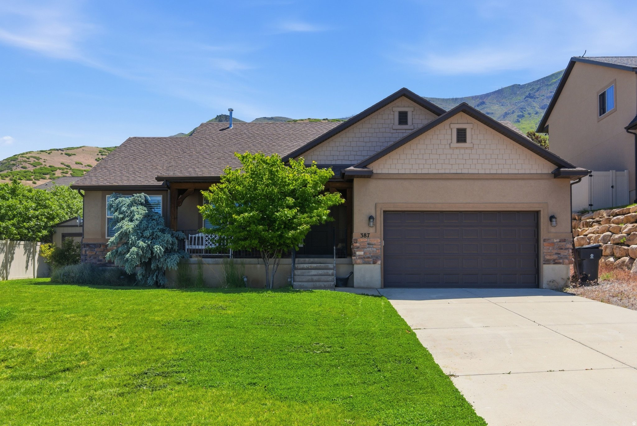 This unique home is nestled on Santaquin's desirable east bench, offering breathtaking mountain and valley views. Enjoy direct access to nearby hiking, biking, and outdoor recreation while still being just minutes from town. Beautifully maintained and thoughtfully designed, this custom home features fresh two-tone paint, carpet, vaulted ceilings, rich hickory wood flooring, and main floor living. The stunning kitchen combines beauty and function with knotty alder cabinetry, a large island bar, and a spacious walk-in pantry. The generous primary suite features vaulted ceilings, a separate tub and shower, and a relaxing retreat-like atmosphere. The full unfinished basement provides endless possibilities to create additional living space tailored to your needs. Additional features include a cold storage room with shelving, water softener, and a tankless water heater. This exceptional property offers the perfect blend of custom craftsmanship, outdoor lifestyle, and spectacular east bench living.