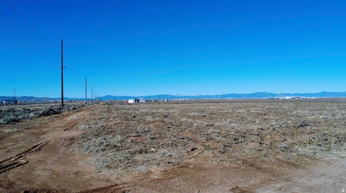 Prime 0.79-acre parcel offering exceptional opportunity with highway frontage and excellent year-round access. Property includes a brand new shared well to be installed prior to closing, an approved well permit, and a valuable 0.50 acre-foot water right. Power is located along the South property line. Well is shared with the adjoining parcel to the north via a recorded well share agreement. Ideal for a custom homesite, manufactured home, mini-ranch, hobby farm, barndominium, or approved home-based business. Ample space for RV parking, equipment storage, or future expansion. Investor-friendly location in a growing corridor. Adjacent 0.87-acre parcel to the north is also available-purchase individually or together for expanded development potential.