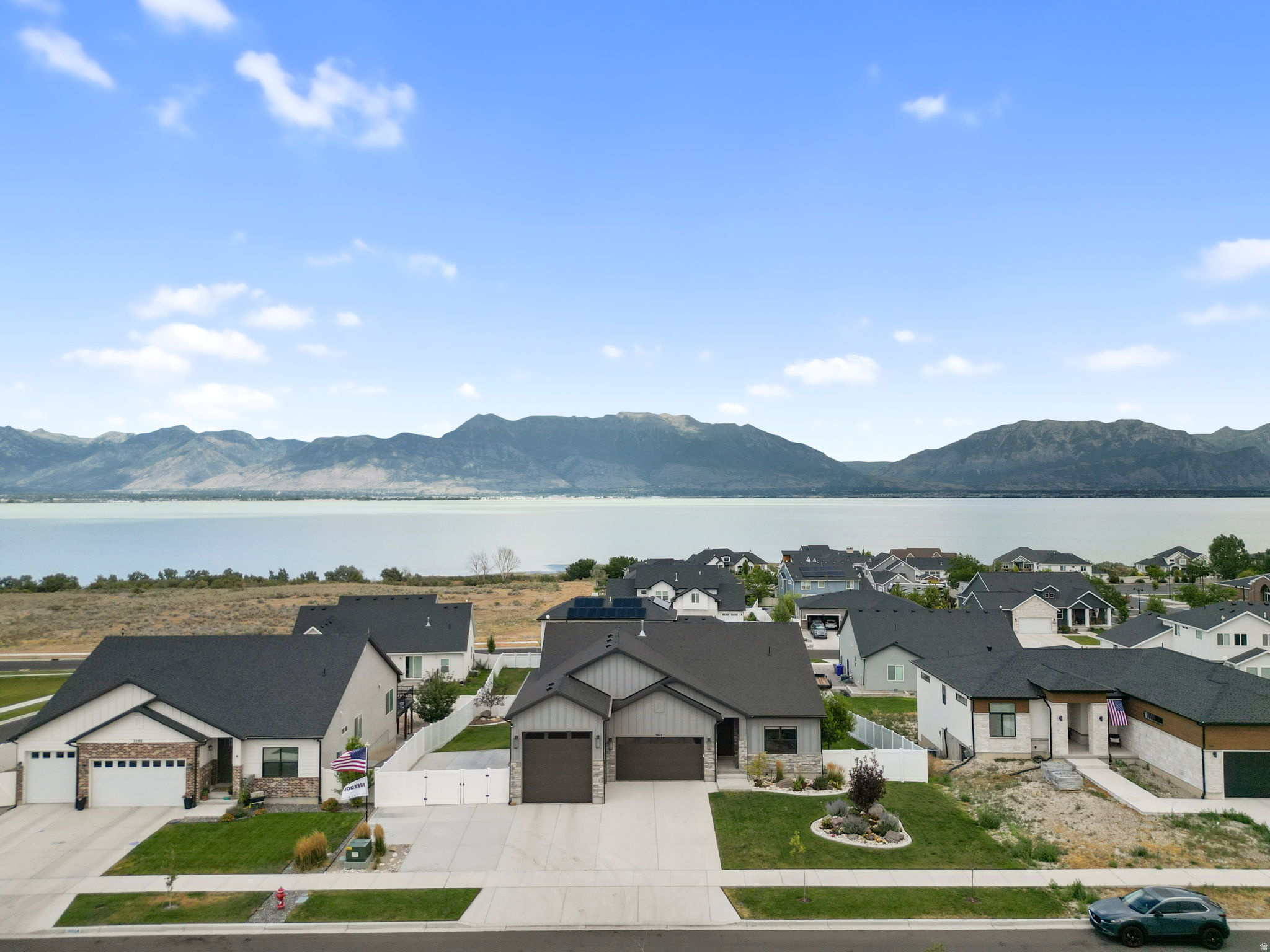 Million-Dollar Views Meet Semi-Custom Luxury in Coveted Catalina Bay! Welcome to Catalina Bay, one of Saratoga Springs' most sought-after communities, where breathtaking views of Utah Lake and the Majestic Wasatch Mountains create a lifestyle unlike any other. Perfectly situated on a peaceful cul-de-sac, this exceptional semi-custom home offers the ideal blend of luxury, comfort, and outdoor adventure. From the moment you enter, you'll be captivated by the abundance of natural light that fills the home, highlighting the open-concept design and stunning finishes throughout. The heart of the home is a true Chef's Kitchen, showcasing premium stainless-steel appliances, a gas range, double ovens, custom wood cabinetry, a handcrafted wood hood, and exquisite quartz countertops complemented by striking Leather Granite surfaces-creating a sophisticated space designed for gathering, entertaining, and culinary excellence. Thoughtful upgrades extend throughout the home, including high-end custom wood closet organizers in every closet, providing both elegance and functionality. The spacious, fully finished walkout basement offers additional living and entertaining space while providing direct access to your private backyard retreat complete with a cozy fire pit-perfect for relaxing evenings under the stars. Designed with outdoor enthusiasts and adventurers in mind, this property boasts an impressive 12' x 12' RV garage that doubles as a deep tandem fourth-car garage, providing exceptional flexibility and storage. The expansive RV parking pad features a dedicated 50-amp hookup, while the RV garage includes its own 30-amp hookup, making it easy to accommodate your RV, recreational vehicles, or workshop needs. These extensive upgrades add tremendous value and convenience, setting this home apart from others and offering capabilities rarely found in today's market. Living in Catalina Bay means enjoying the very best of Utah's outdoor lifestyle. Just minutes away, you'll find Talons Cove Golf Course, Utah Lake, scenic hiking and biking trails, off-road recreation areas, shooting ranges, camping destinations, and a brand-new grocery store currently under construction. In addition, you'll be less than 15 minutes from premier shopping centers, retail destinations, dining establishments, and everyday conveniences-offering a lifestyle that seamlessly meets all your needs while maintaining the peace and serenity of this exceptional community. With stunning million-dollar views, premium upgrades, abundant natural light, incredible RV accommodations, and an unbeatable location, this remarkable Catalina Bay home offers a rare opportunity to enjoy luxury living surrounded by some of Utah's most spectacular scenery.