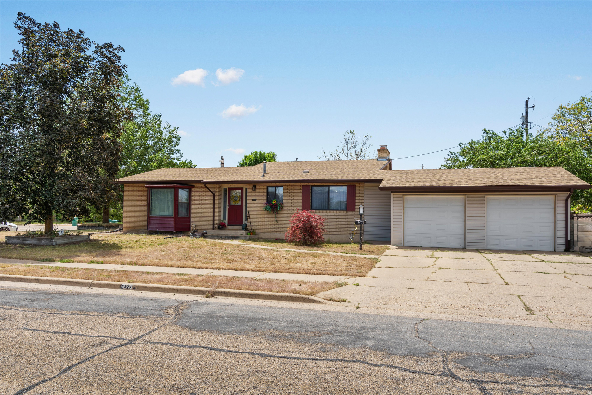 Beautifully updated home on an oversized corner lot tucked inside a peaceful cul-de-sac in Roy. This spacious property offers an updated kitchen, LVP flooring, a large remodeled laundry room, and custom railing details that add a modern touch throughout. The functional layout includes two family rooms and a walkout lower level opening to a covered patio and expansive yard space. The massive basement room is perfect for entertaining and making sure everyone has plenty of space. This home offers lots of storage with an extended garage space. Featuring a tankless water heater for added efficiency and comfort. Tons of RV parking and more. Schedule your showing today!