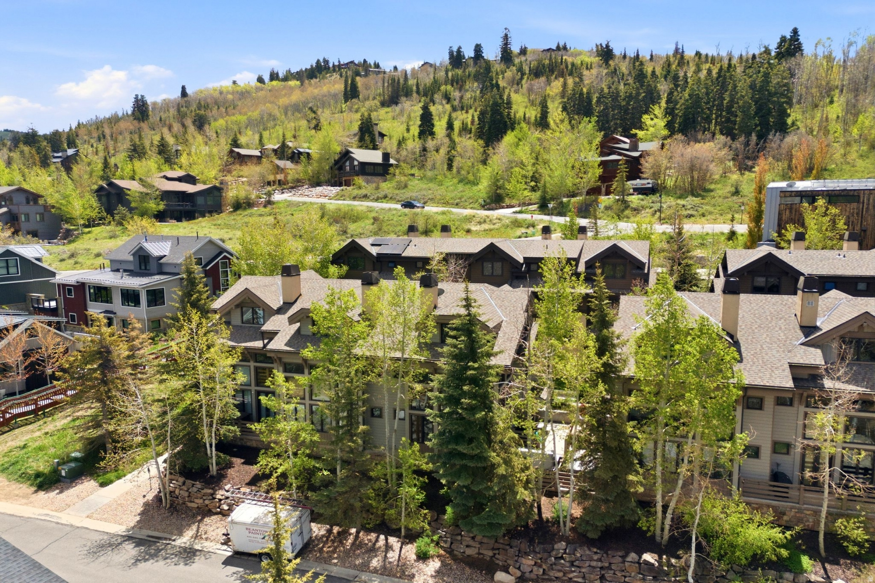 Located adjacent to Deer Valley Resort, this turn-key Portico townhome places you in the center of one of the most desirable mountain lifestyles in the country. Just a short walk to Snow Park Lodge and Historic Main Street, owners and guests enjoy immediate access to world-class skiing, award-winning restaurants, boutique shopping, galleries, live music, hiking and biking trails, and year-round events. The free Park City transit route is nearby, providing effortless access throughout town, including Park City Mountain Resort and the greater Park City trail system.   Deer Valley continues to stand apart as one of North America's premier ski destinations, known for impeccably groomed runs, luxury amenities, and exceptional service. During the summer months, the area transforms into a recreation hub with concerts, mountain biking, scenic chairlift rides, fly fishing, golf, and endless outdoor activities right outside your door.  This spacious 3-bedroom, 3-bath residence offers approximately 1,600 square feet with vaulted ceilings, a stone fireplace, abundant natural light, and outdoor living spaces to enjoy the alpine setting. Offered fully furnished and completely turn-key, the property is ready for immediate enjoyment or income generation. Nightly rentals are permitted, creating exceptional flexibility for owners seeking a primary residence, second home, or investment property.  Additional features include underground parking, elevator access, ski storage, guest parking, and HOA-managed snow removal and exterior maintenance, allowing for true low-maintenance mountain living in an unbeatable Deer Valley location.
