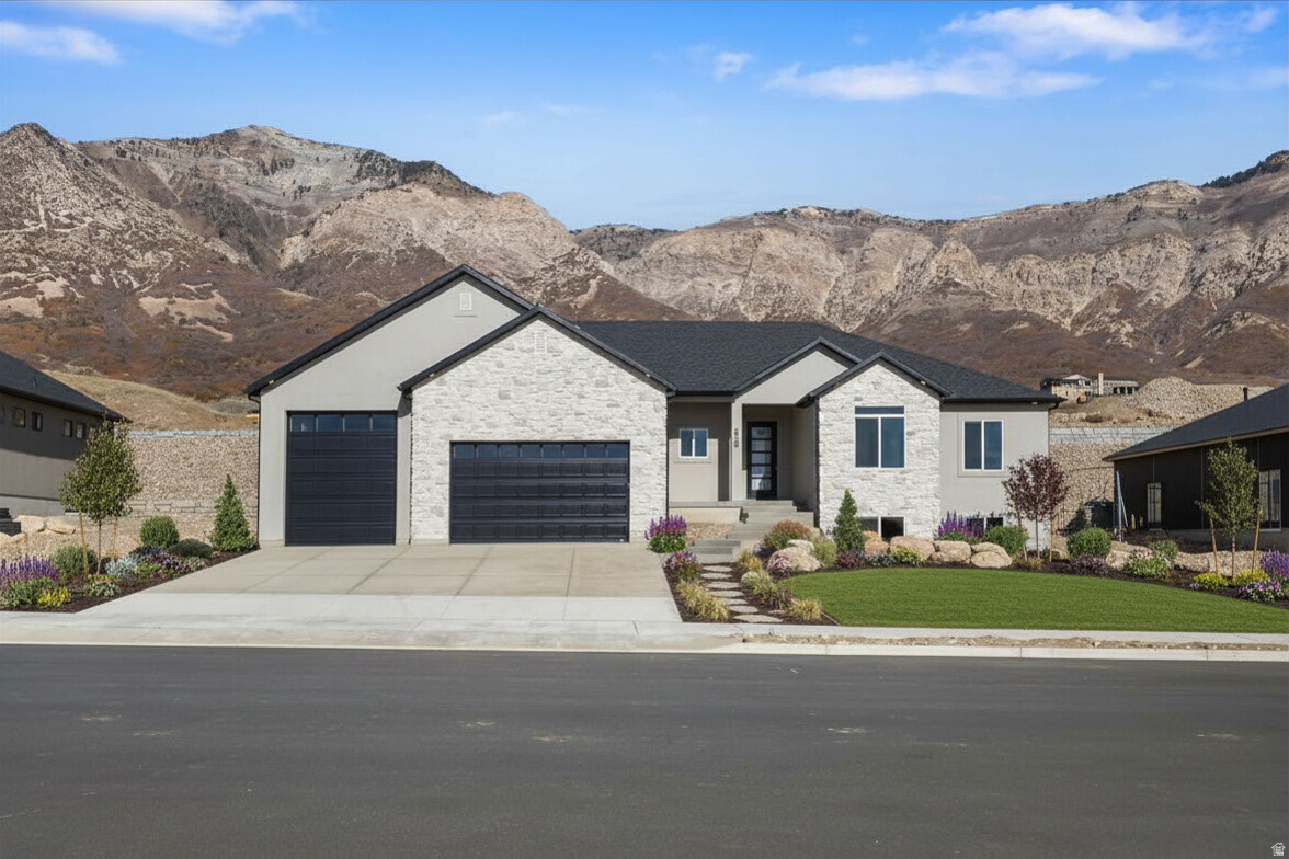 **Price Improved $45k-Cheapest home in the subdivision!!** Come to the top of North Ogden and take in the stunning mountain and valley views! This brand-new rambler is filled with natural light, thanks to expansive windows that showcase the scenery and create a warm, welcoming main level. The gourmet kitchen is designed to impress, featuring a 66" fridge/freezer combo, decorative hood vented outside, gas cooktop, double ovens, and a generous walk-in pantry-perfect for both entertaining and everyday living. Enjoy 9' ceilings on both the main level and basement, and relax in the great room with a cozy gas log fireplace framed by built-in cabinetry and floating shelves. The primary suite offers a peaceful retreat with a separate tub and shower, stylish barn door, double sinks with a dedicated makeup vanity, and a spacious walk-in closet. Step outside to the 20x12 covered patio-ideal for soaking in the views year-round. The walk-out basement provides excellent potential for a future ADU, and the 4-car garage comes equipped with an EV charging outlet and epoxy floors. This home perfectly blends comfort, style, and breathtaking surroundings-don't miss your chance to see it!
