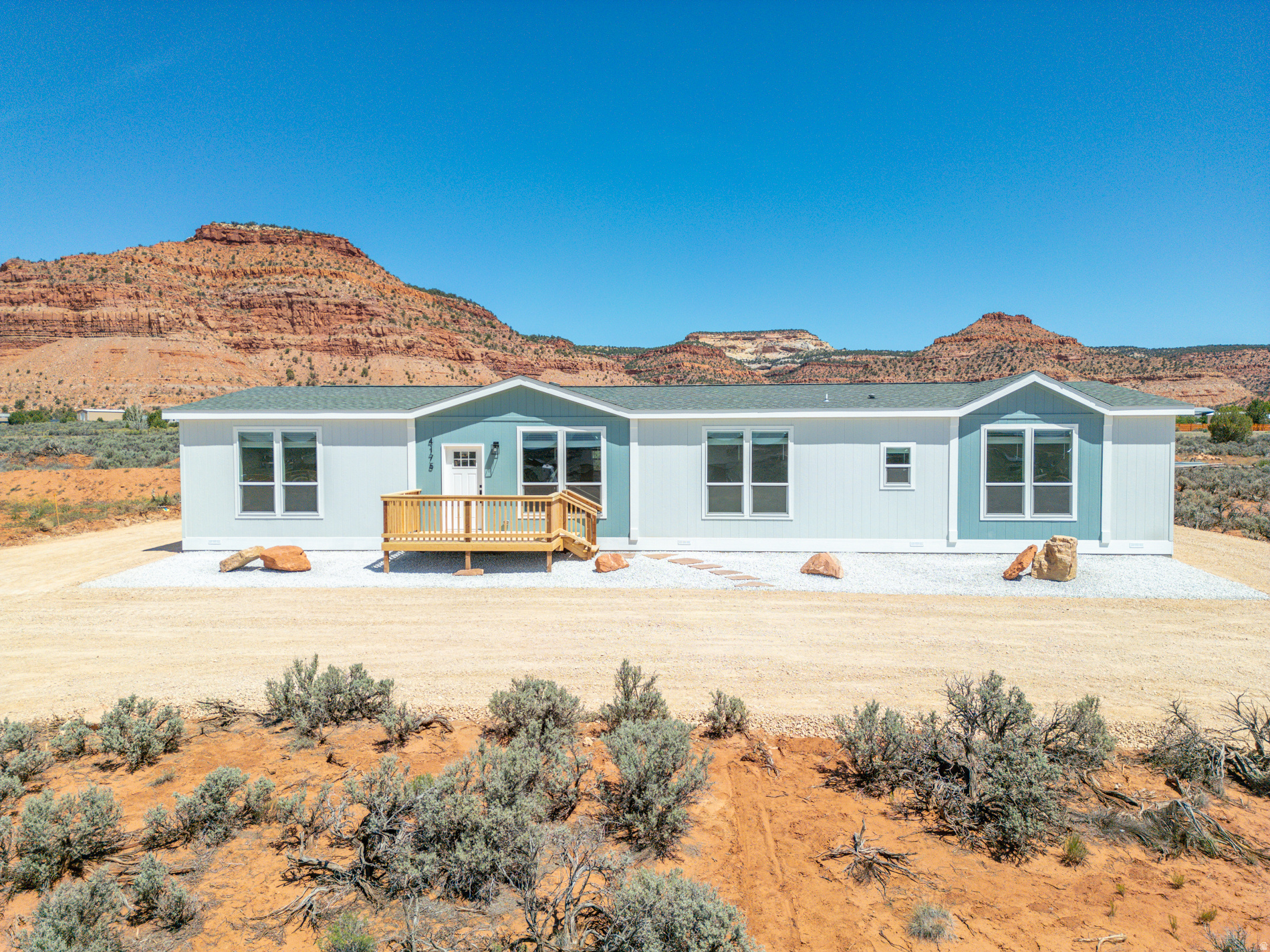 Set against breathtaking Southern Utah red rock views, this is not your average manufactured home in Kanab. One of the only models offering 4 bedrooms with a second living space, this 1-acre property delivers a rare combination of size, flexibility, and presence.  No expense was spared in the setup, from the clean landscaped exterior to the perfectly designed circular driveway that creates a true sense of arrival. Inside, the 2,280 sq ft layout features an open-concept main living area, a spacious kitchen with island, and a split-bedroom design for added privacy. A second living room or flex space gives you options for an office, media room, or additional living area.  Step outside and take it all in. Front and back decks create multiple outdoor living spaces to enjoy the surrounding scenery, with 360-degree views that truly set this property apart. The 1-acre lot offers room to expand, along with ample space for multiple RVs, trailers, and recreational vehicles.  Located just a short drive from some of the most sought-after destinations in the Southwest, including Zion National Park, Bryce Canyon National Park, Lake Powell, and the Grand Canyon, this property offers access to world-class recreation right out your front door.  With 1 acre, minimal restrictions, and flexible parcel use, this property opens the door to a wide range of possibilities beyond standard residential living. Buyer to verify all potential uses with local zoning.  Square footage figures are provided as a courtesy estimate only and were obtained from builder plans.  Buyer is advised to obtain an independent measurement.  Reference the original model for full specifications and layout details. https://claytonbuckeyeharmony.com/