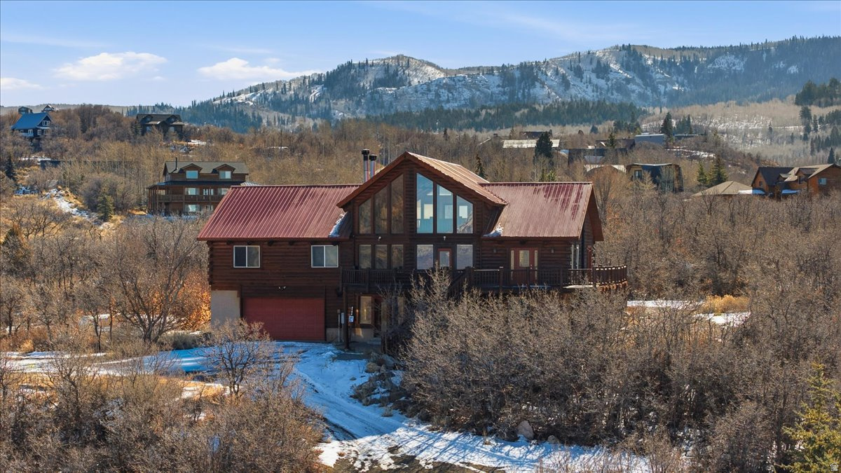 Rare opportunity to own a spacious mountain cabin retreat on 2.37 wooded acres in the gated Timber Lakes community of Heber. This multi-level log cabin offers over 4,500 sq ft of living space with vaulted ceilings, multiple fireplaces, a walkout basement, and expansive deck areas designed to take in the surrounding mountain setting. The home features generous living and gathering spaces, multiple bedrooms across levels, and flexible-use areas ideal for hosting, seasonal living, or full-time residence. Large windows and covered deck spaces bring the outdoors in, while the wooded lot provides privacy and a true mountain experience. Property includes attached tandem garage parking, RV parking capability, workshop/storage areas, and basement storage. Located within a private, gated recreational mountain community with year-round access, private roads, hiking and biking trails, and on-site HOA services. Minutes from Heber Valley recreation, world-class fishing, boating, skiing, and trail systems - yet tucked away in a secure mountain setting. Perfect as a primary residence, second home, or legacy mountain getaway with convenient access to valley amenities while enjoying a peaceful alpine environment. Buyer to verify all information.  Square footage figures are provided as a courtesy estimate only.  Buyer is advised to obtain an independent measurement.