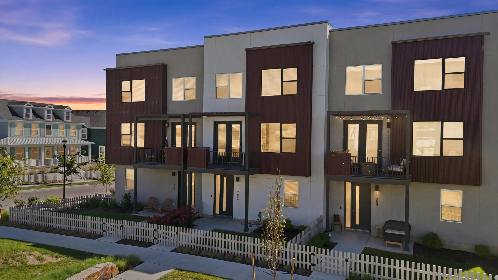 Welcome to Daybreak, one of Utah's most sought-after master-planned communities. Ideally located near parks, trails, Oquirrh Lake, Downtown Daybreak, TRAX, the Salt Lake Bees Stadium, restaurants, shopping, and countless community events, this beautifully maintained home offers the perfect blend of comfort, convenience, and lifestyle.  The open, light-filled floor plan is designed for both everyday living and entertaining, featuring a spacious kitchen with a large island, custom built-in shelving, and an inviting family room. Thoughtful upgrades include a custom electric fireplace, Ring doorbell, and keyless entry.  Upstairs, you'll find three bedrooms and two full bathrooms, including a spacious primary suite with a separate tub and shower, walk-in closet, and private covered balcony showcasing breathtaking views of the Wasatch Mountains. A secondary bedroom features its own private full bathroom and walk-in closet, providing added privacy and flexibility.  The garage has been thoughtfully enhanced to include two additional bedrooms with heating and cooling supplied by the home's main HVAC system. A full bathroom with washer and dryer hookups has also been added, creating flexible space that can be used for guests, a home office, hobbies, or a variety of other needs. The property also offers additional driveway parking for added convenience.  As a Daybreak resident, you'll enjoy access to pools, parks, trails, lakes, fitness facilities, community centers, high-speed internet, and full landscaping maintenance through the HOA.  This is a rare opportunity to own a move-in-ready home with stunning mountain views, versatile living spaces, and access to the exceptional amenities and vibrant lifestyle that make Daybreak one of Utah's premier communities.