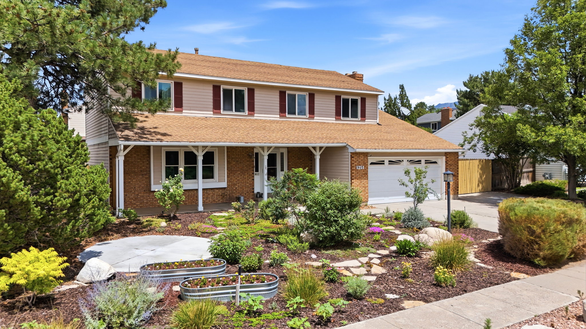 Wonderfully cared for, this two-story home sits on the Sandy/Draper border with mountain and valley views and a layout that simply feels good to live in. The remodeled kitchen serves as the heart of the home, flowing naturally into comfortable living spaces designed for everyday life as well as entertaining. Step outside to an inviting covered patio overlooking a serene, intentionally natural landscape where mature trees, seasonal blooms, and peaceful outdoor spaces create a backyard that's meant to be experienced rather than simply maintained. Conveniently located within walking distance of the local elementary and middle schools, and just minutes from parks, shopping, dining, and everyday conveniences, this home offers the perfect balance of comfort, beauty, and accessibility. If you've been looking for a home with character, thoughtful updates, and outdoor spaces that invite you to slow down and enjoy life, this one is well worth seeing in person.
