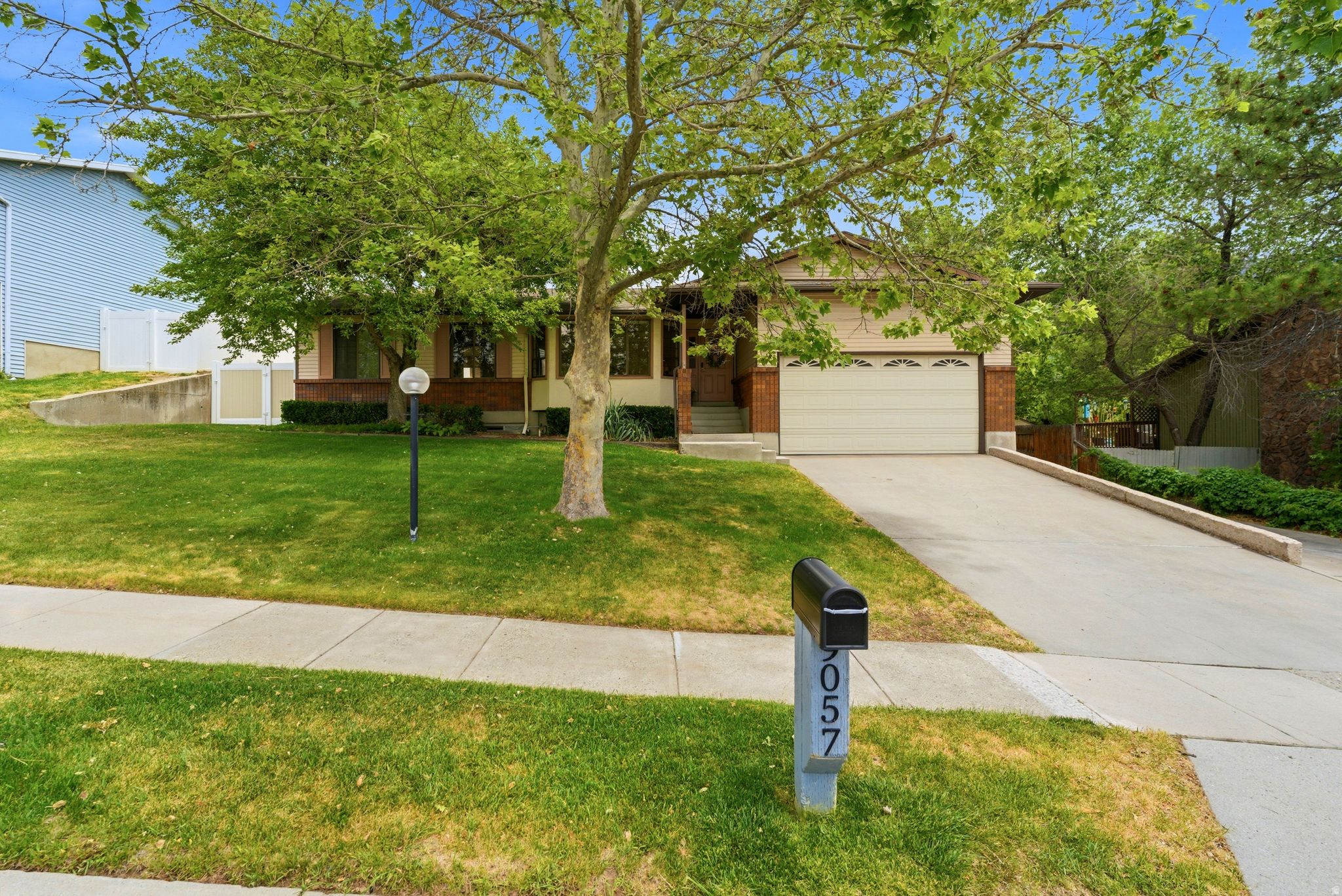 Enjoy coming home to this wonderful 6-bedroom, 3-bathroom home located in the highly desirable Willow Creek Meadows neighborhood. This beautiful home features an updated kitchen with white cabinetry, stainless steel appliances, and warm wood flooring. The inviting great room offers a cozy fireplace, while neutral tones throughout create a bright and welcoming atmosphere. Additional features include a semi-formal living room, spacious kids' bedrooms, a large primary suite with a walk-in closet and private en-suite bathroom, and a convenient main-floor laundry room.  The fully finished basement offers a complete mother-in-law apartment with a separate entrance, its own laundry area, fireplace, expansive family room, three spacious bedrooms, and abundant storage space-perfect for multi-generational living.  Situated on a generous .39-acre lot, this property offers spectacular views, a large back deck ideal for entertaining, a fully fenced yard, pull through RV parking, and a 2-car garage. Centrally located to schools, shopping, and minutes from Big & Little Cottonwood Canyons. A Must See!