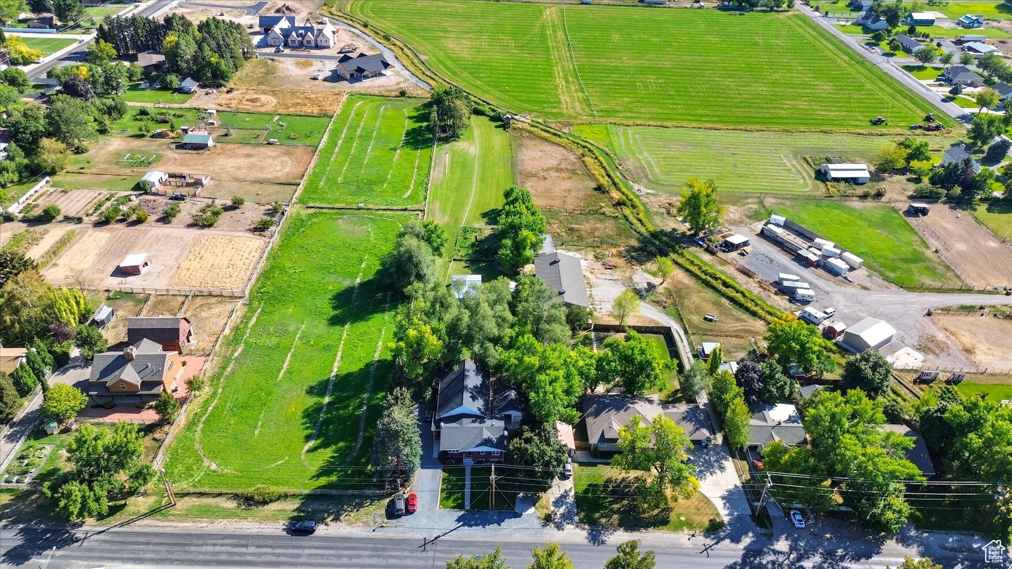 PRICE DROP!  PLUS seller willing to offer $5k towards closing costs or incentives used how buyer would like.  UNIQUE doesn't even begin to describe this property.  It has endless possibilities.  Home is effectively built in 2020.  The sellers did a full remodel on current home then added over 3200 square feet in the addition built in 2020.  The home includes 3 kitchens, 3 separate living spaces, options galore.   The finishes throughout the entire home are gorgeous with colorful trim, brick walls, unique layouts, custom cabinetry and beautiful flooring.  A large family could occupy main floor living and basement then still have a mother in law apartment, or separate living spaces with extended family.  There are too many options to list. 7 bedrooms could be 8, 5 bathrooms and sitting on 1.76 acres with 2 out buildings while being surrounded with beautiful established trees.  This property boasts panoramic Cache Valley views and spectacular sunsets. Property includes 1 1/2 shares of water along with the ability to have 3 horses, stalls and tack room or space for other animals.  It really is one you have to see in person to appreciate all the detail to the home, the options it could provide, and the amazing yard.  Square footage figures are provided as a courtesy estimate only and were obtained from county .  Buyer is advised to obtain an independent measurement.