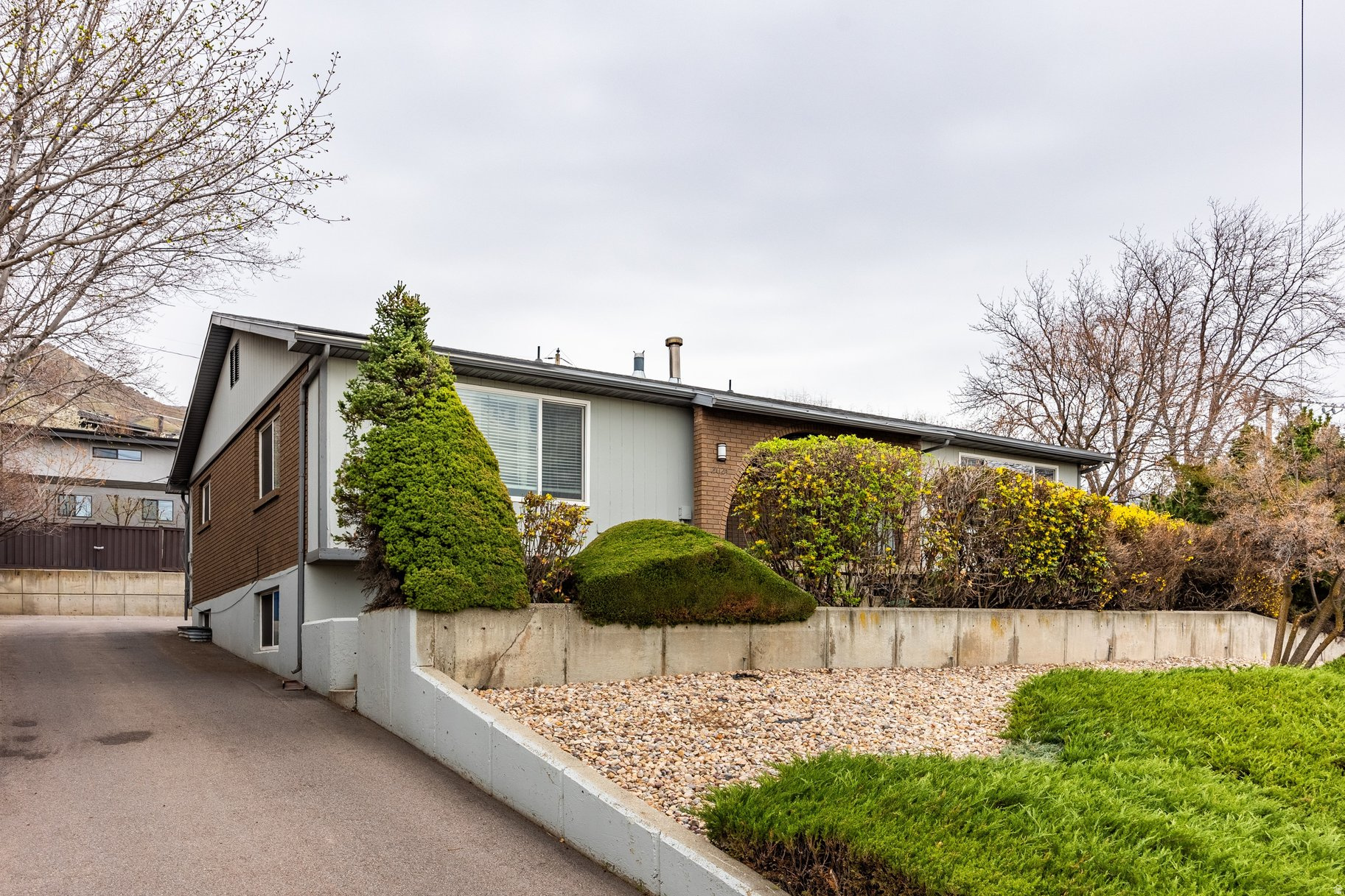 This inviting brick duplex is ideally located just above Foothill on Salt Lake City's coveted east bench. This setting offers exceptional accessibility to the University of Utah, Westminster College, downtown Salt Lake City, and the area's renowned recreational opportunities, all while benefiting from a quieter residential street set back from the congestion of main thoroughfares. A long private drive provides a sense of arrival and separation, with each unit offering a covered carport with storage and two additional dedicated parking spaces. Set on a .23-acre lot, the property offers meaningful outdoor living, a rare amenity for duplex properties. The South unit is currently vacant, has been thoughtfully improved with a large paver patio, small deck, and fully fenced yard, creating a private and serene outdoor environment with space for dining, planter boxes, and lounging. A similar configuration could be implemented for the north unit, further enhancing both livability and value. The units are well maintained and offer flexible, functional layouts. The South unit features three bedrooms, two bathrooms, and a non-conforming fourth bedroom offering flexibility for additional sleeping quarters, a den, office, or gym. The North unit is currently configured with three bedrooms and two bathrooms, including one lower-level bedroom that is exceptionally large and could easily be adapted to mirror the opposite unit by creating either a non-conforming fourth bedroom or an expansive lower-level den, family room, gym, or flex space. As mirror-image units with comparable square footage, the configuration presents meaningful upside for both livability and long-term income potential. Both units offer generous gathering spaces on each level, large kitchens with room for informal dining, and private in-unit laundry. Recent improvements include a newer roof within the last five years and updated appliances. With the University of Utah academic year just concluding, the upcoming leasing cycle presents a timely opportunity to capture fresh tenant demand. With one unit vacant, this property offers immediate flexibility for an owner-occupant or the opportunity to reposition rents. A compelling offering in one of Salt Lake's most desirable east bench neighborhoods, combining stability, flexibility, and long-term potential.