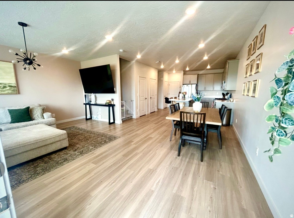Beautiful townhome featuring a striking white farmhouse exterior, fenced patio area, and breathtaking valley views. The bright and spacious main level offers an open-concept layout perfect for both everyday living and entertaining. The kitchen is equipped with stainless steel appliances, a gas range, and seamless flow into the dining and family room areas. A convenient pantry and half bath complete the main floor. Upstairs, you'll find a spacious primary suite with a large bathroom, double vanity, and walk-in closet. Two additional bedrooms, a full bathroom, a dedicated laundry room, and a versatile loft/flex space provide plenty of room for family, guests, or a home office. The unfinished basement is already rough plumbed for an additional bathroom and offers space for another bedroom and living area, giving you the opportunity to customize and expand to fit your needs. This townhome truly has it all - stylish design, functional living space, and room to grow. Conveniently located with easy access throughout the valley via Redwood Road, I-15, and Mountain View Corridor