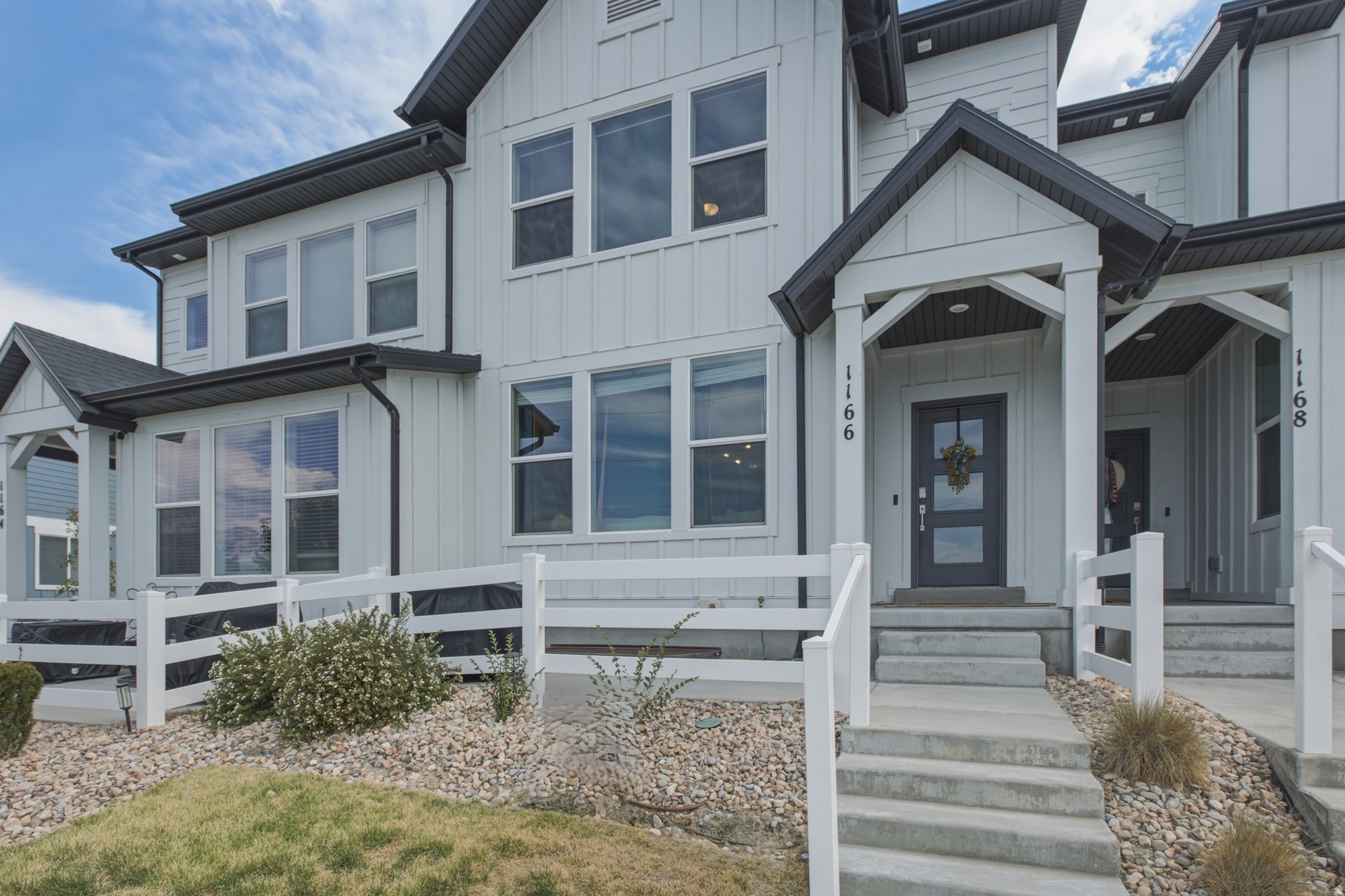 Beautiful townhome featuring a striking white farmhouse exterior, fenced patio area, and breathtaking valley views. The bright and spacious main level offers an open-concept layout perfect for both everyday living and entertaining. The kitchen is equipped with stainless steel appliances, a gas range, and seamless flow into the dining and family room areas. A convenient pantry and half bath complete the main floor. Upstairs, you'll find a spacious primary suite with a large bathroom, double vanity, and walk-in closet. Two additional bedrooms, a full bathroom, a dedicated laundry room, and a versatile loft/flex space provide plenty of room for family, guests, or a home office. The unfinished basement is already rough plumbed for an additional bathroom and offers space for another bedroom and living area, giving you the opportunity to customize and expand to fit your needs. This townhome truly has it all - stylish design, functional living space, and room to grow. Conveniently located with easy access throughout the valley via Redwood Road, I-15, and Mountain View Corridor