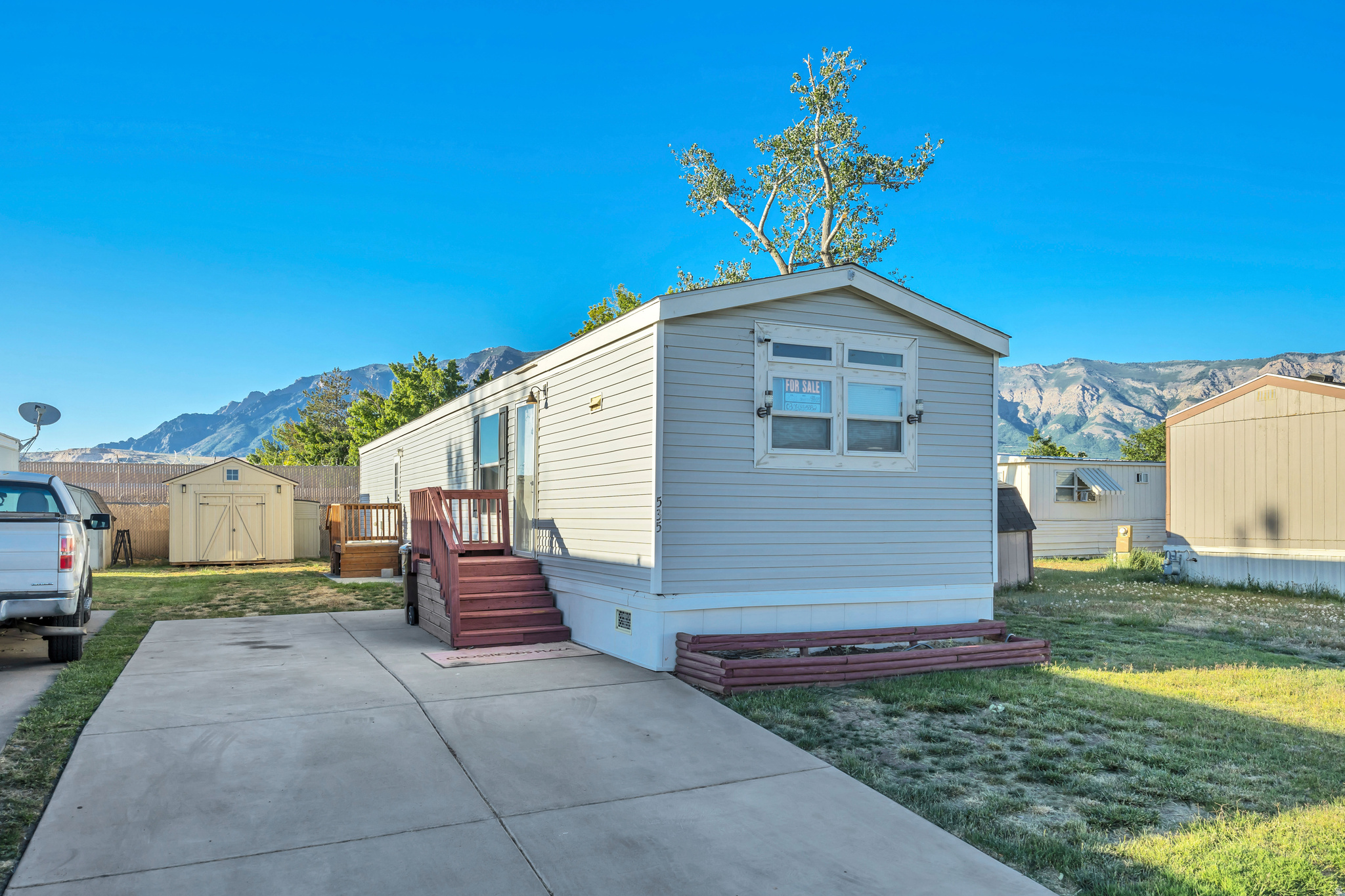 Evergreen Village Value! Priced below comparable homes in the community and ready for a quick sale with title in hand. This well-maintained 2021 Champion manufactured home offers 980 sq. ft. of comfortable living space with 3 bedrooms and 2 bathrooms. Featuring a spacious front living room, open kitchen, and year-round comfort from central heating and air conditioning. Outside, enjoy a 10' x 12' storage shed with tile flooring, an additional garden shed, and a rare extra-deep double-wide driveway, providing ample parking and storage space. Residents enjoy access to a swimming pool, two playgrounds, and a safe friendly neighborhood atmosphere. Don't miss this opportunity! "All footage and measurements are deemed reliable but not guaranteed. Buyer is advised to obtain their own measurements and complete due-diligence to their satisfaction."