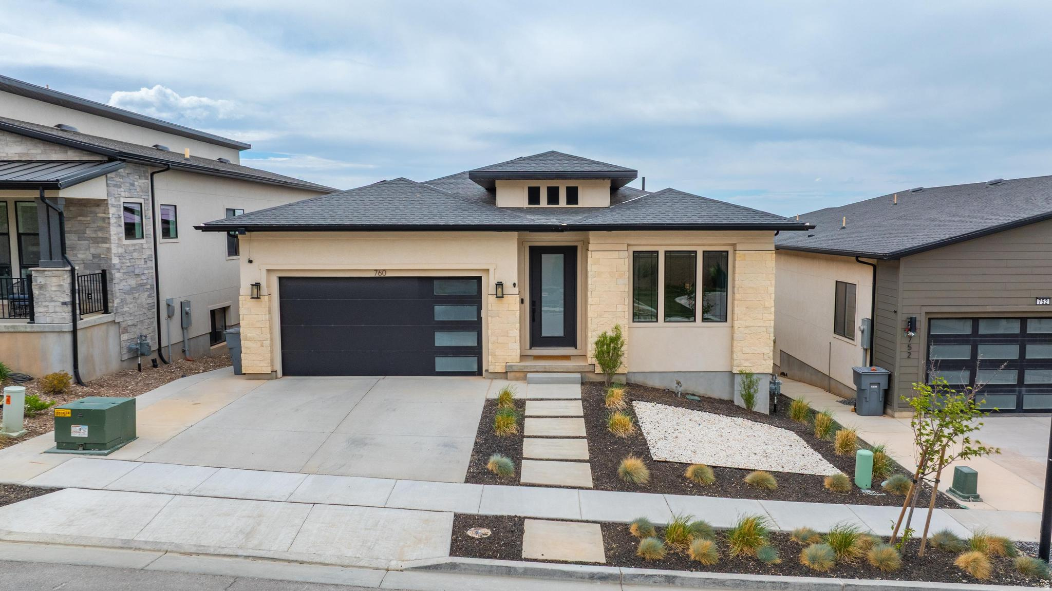 Beautifully designed 2022 rambler in North Salt Lake offering nearly 4,000 square feet of living space with 6 bedrooms, 4.5 bathrooms, and dual laundry rooms. The open-concept floor plan features 10-foot ceilings, 8-foot doors, designer finishes, and a smart-home lighting system throughout. A 20-foot sliding glass door opens to unobstructed panoramic views of the Great Salt Lake Valley, Oquirrh Mountains, and stunning sunsets, with no rear neighbors providing added privacy. The fully finished lower level includes a spacious second living area ideal for multigenerational living, guests, or entertaining. Additional features include a fully paid-off solar system and EV charger. Conveniently located near Eaglewood Golf Course, downtown Salt Lake City, Salt Lake City International Airport, ski resorts, and miles of hiking and biking trails. Square footage figures are provided as a courtesy estimate only. Buyer is advised to obtain an independent measurement.
