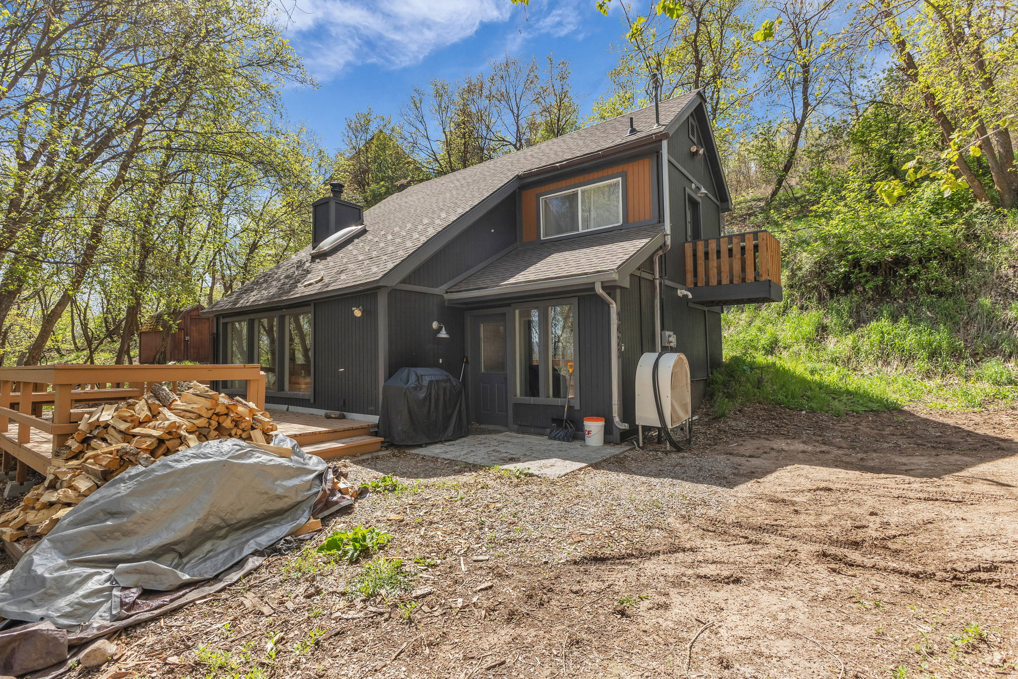 Tucked away in the serene mountain setting above Midway, this inviting cabin in Swiss Mountain Estates offers the perfect blend of privacy, comfort, and year-round recreation. Situated on a beautifully wooded and secluded .56-acre lot, this charming two-bedroom retreat captures the essence of mountain living with its warm contemporary design, open-concept layout, and stunning natural surroundings. The spacious kitchen features stainless steel appliances, ample counter space, and flows seamlessly into the dining and great room area, where a dramatic floor-to-ceiling wood-burning fireplace creates the perfect gathering space after a day of adventure. Expansive windows bring in natural light and frame the breathtaking mountain scenery, while easy access to the oversized deck makes entertaining effortless or provides the ideal spot to relax and soak in the peaceful alpine atmosphere. Whether you're seeking a full-time residence, weekend getaway, or investment opportunity, this mountain escape places endless outdoor recreation right at your doorstep with hiking, biking, snowmobiling, skiing, fishing. Deer Valley East and Mayflower are also only 15 minutes away, making this an exceptional opportunity to enjoy both peaceful mountain living and convenient access to world-class skiing, dining, and recreation.