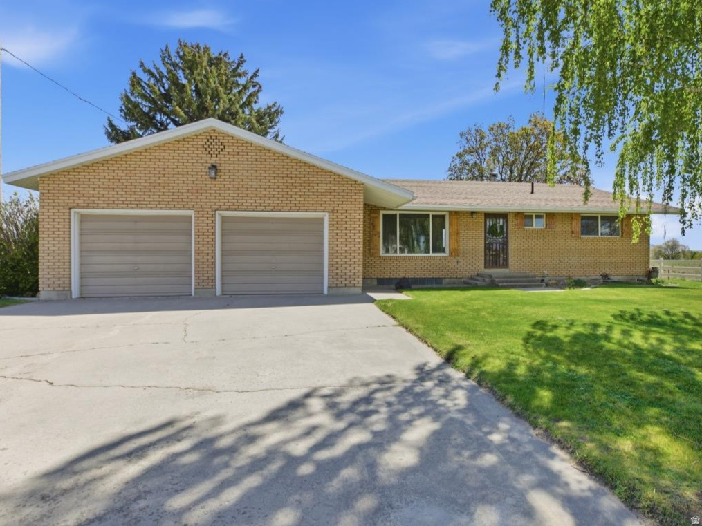 Solid brick home offering 4 bedrooms and 2 bathrooms, thoughtfully updated throughout while maintaining its classic charm. This well-maintained property features a beautifully landscaped yard with mature trees and a full sprinkler system for easy upkeep. Enjoy abundant natural and added lighting throughout the home, creating a warm and inviting atmosphere. The spacious 2-car garage includes extra storage space, providing both convenience and functionality. Step outside to a covered back patio-perfect for relaxing and enjoying cool afternoon shade. A true combination of comfort, quality, and care-this home is ready to impress!
