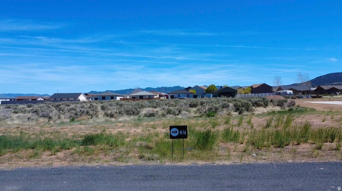 Come experience country living at its finest in Cottonwood Ranches--Enterprise's newest premier equestrian subdivision. Designed with horse lovers and those seeking space in mind, this community offers large lots ranging from 0.5 to 1.5 acres. Lot #16 features 1.01 acres of flat, usable land--perfect for building your dream home, barn, and corrals. Located within Enterprise city limits, utilities include water, power, fiber optics, and natural gas, with septic required for sewer. Up to 5 large animals are permitted. Enjoy the charm of Enterprise, a self-sufficient rural community offering grocery stores, restaurants, schools, medical services, and more--all while being just 40 minutes from St. George and Cedar City. Bring your own builder and create your ideal lifestyle. Impact fees are approximately $13,000.