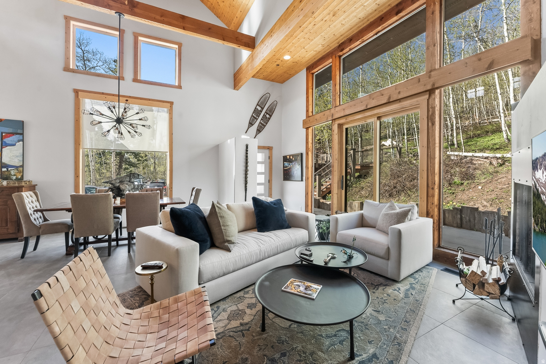 Nestled in the mountains just 15 minutes from Kimball Junction & located within the sought-after Park City City School District. This exceptional home blends cozy with elevated mountain living. Offering 4,100 square feet,the residence features 4 Bedrooms & 5 Bathrooms, with a thought-ful layout designed for both privacy and gathering.The primary suite provides a peaceful retreat located near the full-size laundry room.  The main level welcomes you with a light-filled kitchen that opens to a screened-in porch.perfect for enjoying fresh mountain air .A spacious family room with walk-out access to the back patio creates seemless indoor-outdoor living.  An ensuite second primary bedroom & charming bunk room complete this level.  Upstairs  an open loft currently serves as a gameroom and is accompanied by a full bath offering flexable space for entertainment or relaxation.   Above the two car garage is a private ensuite bedroom and living area provide an ideal setup for guests or extended stays. As an added benefit, the Stagecoach Estates HOA has approved paving Kimball Canyon Road, enhancing accessibility and long term value
