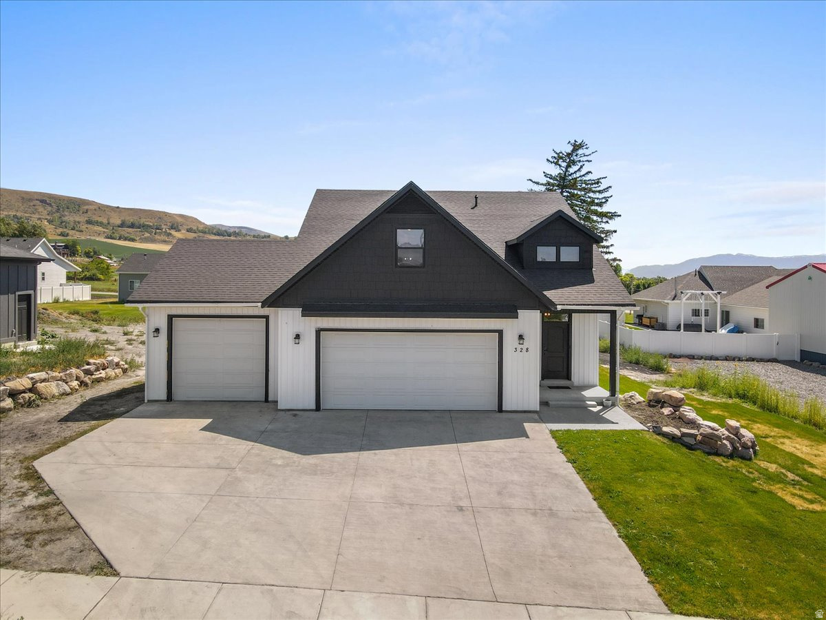 *** PRICE REDUCTION! This home has huge protentional! Price reflects current condition and work that needs to be done. **** Conveniently located just 15 minutes from downtown Logan, and just 6 minutes from Cherry Peak Ski Resort (with summer concert series). This 7 bedroom home is nestled in a peaceful neighborhood with striking mountain views! A few steps across the street brings you to a cozy park and playground area. In the 3 car garage you will find epoxy coated floors with a rare mechanics pit, a dream set up for car enthusiasts! The fully finished walkout basement has 3 bedrooms, a full bath and a brand new kitchenette. This (ADU) Mother in Law apartment has its own private entrance outside, but can also be accessed from inside should you chose not to rent it out. On the top floor you will find 3 bedrooms, a full bathroom and a bonus loft! The oversized loft would make a great playroom, hobby area or an extra bedroom! The main floor boasts an open floor plan with the kitchen and living room. Stainless steel appliances. The spacious master suite features a large bathroom with a separate tub and shower, and walk in closet. Bonus : 220 hook up in the garage along with hot tub hook ups outback, as well as tankless water heater and separate temperature controls for the top floor! This home is a blank slate, just waiting for its new owners to put in the final touches to make it theirs!