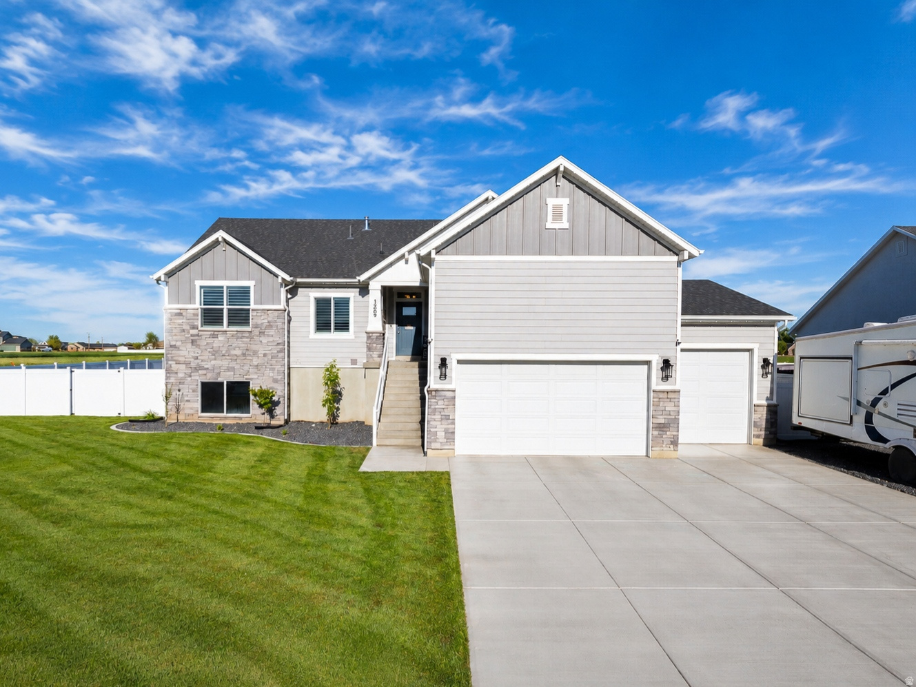 Have you been looking for a home that is better than new? How is that possible, you might wonder? Because this 1-year-old home comes with a FULLY FINISHED and landscaped yard with privacy fencing all around, an automatic sprinkler system, and a fully finished basement, plus a mother-in-law/ADU apartment with separate access, including its own kitchen, 3 bedrooms, and laundry. A few other features include 3 bedrooms on the main level, a large 3-car garage, an electric vehicle charging station, and permanent outdoor programmable lighting.  This is a home you need to see in person to appreciate everything it offers! Call today for a private tour, you'll be glad you did!