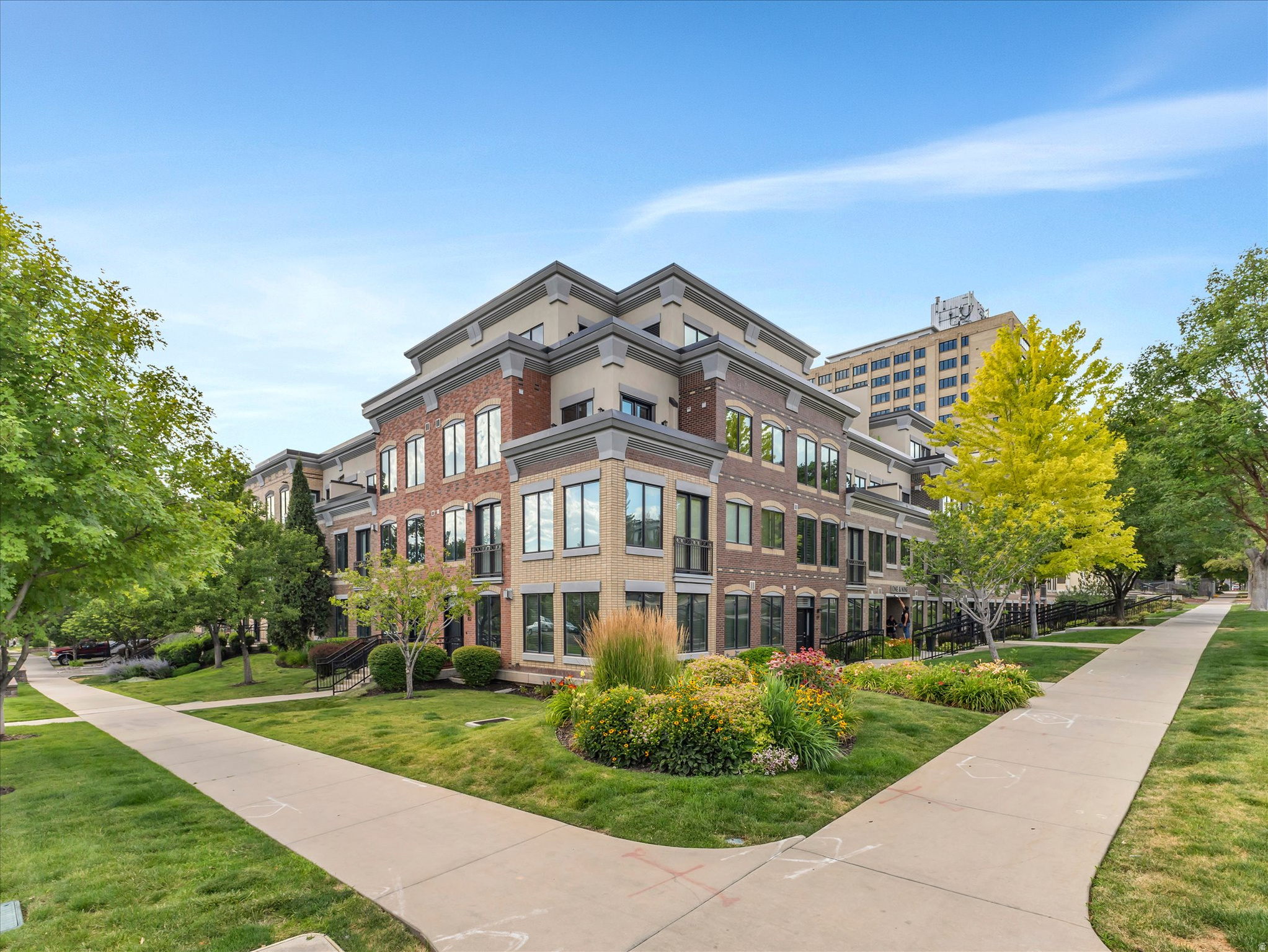 Rarely available first-floor residence at One and Nine, ideally situated in Salt Lake City's desirable east-central neighborhood between downtown and the University of Utah. This premier location offers an exceptional walkable lifestyle with neighborhood restaurants, cafes, boutiques, parks, and cultural attractions just moments from your front door. Residents also enjoy quick access to Sugar House, the Salt Lake International Airport, world-class ski resorts, hiking and biking trails.Designed for both comfort and convenience, this move-in-ready home includes two secure underground parking spaces, a private Tesla charger, and a dedicated storage closet. Recent updates include fresh designer paint, stylish luxury vinyl plank flooring, new carpet, ceiling fans, and new stainless steel kitchen appliances.The expansive open-concept floor plan is ideal for everyday living and entertaining. The gourmet kitchen features abundant cabinetry, granite countertops, a gas range, a spacious center island with bar seating, pendant lighting, and generous prep space. The adjoining great room has oversized windows and an inviting gas fireplace, creating a cozy gathering space.The luxurious primary suite is a true retreat with its own fireplace, dual walk-in closets, and a spa-inspired ensuite bathroom featuring a double vanity, a corner soaking tub, a separate shower, and a private water closet. A generously sized second bedroom also includes its own ensuite bathroom, providing comfort and privacy for guests or family members.One and Nine residents enjoy outstanding amenities, including a heated driveway, a recently renovated fitness center, an elegant clubhouse and gathering room, and a beautiful European-style courtyard complete with new outdoor furnishings and a fire pit.Combining an unbeatable location, generous living spaces, luxurious finishes, and exceptional community amenities, this rare first-floor residence offers sophisticated urban living at its finest.Buyer to verify all HOA info, HOA Fees and dimensions.