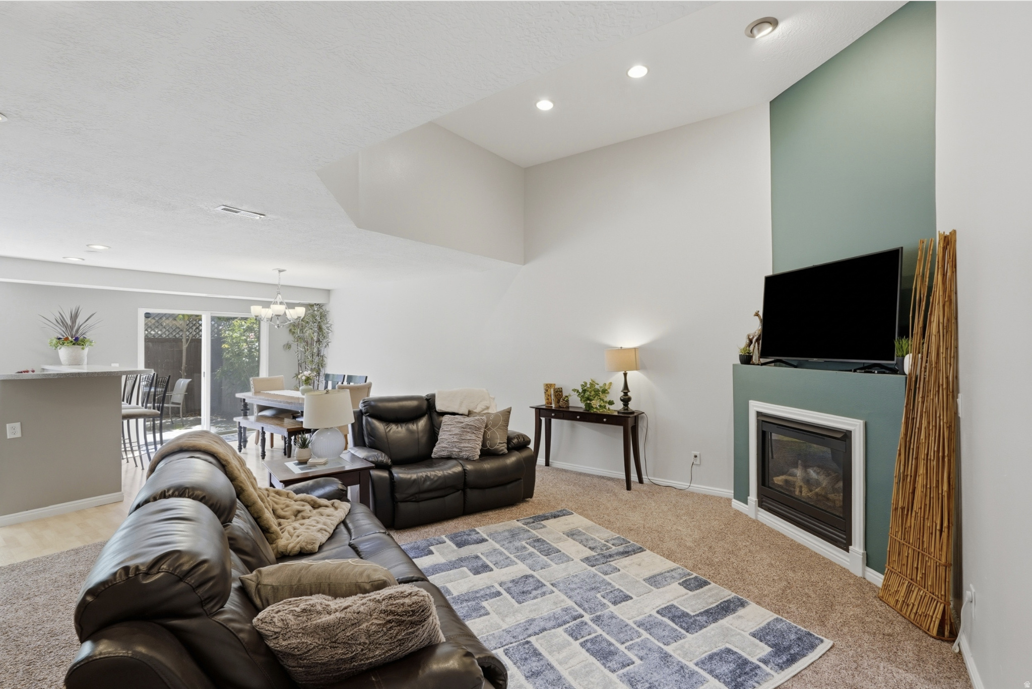 Architecturally stunning open-concept townhome in the highly desirable Sugar House neighborhood. This elegant, move-in-ready 3-bedroom, 2-bath home offers 1,799 square feet and is one of the larger premium units in this gated community. Soaring vaulted ceilings and dramatic sight lines lead to a striking third-story skylight, filling the home with natural light and creating an impressive sense of space. The beautiful contemporary kitchen features stainless steel appliances and flows seamlessly into the dining and living areas, making it ideal for everyday living and entertaining. A cozy gas fireplace anchors the inviting main living space. Brand-new designer paint and updates, epoxy-finished garage floors, and meticulous care throughout make this home truly stand out. The spacious primary suite features a walk-in closet and en-suite bath with a relaxing jetted soaking tub. A versatile loft provides the perfect space for a home office, den, or additional living area, while a large storage closet adds valuable bonus space. Step outside to your private landscaped backyard retreat, where mature trees provide welcome shade and a peaceful setting for relaxing or entertaining. Tucked away in a quiet location just one block from the S-Line TRAX station and the Greenway trail, you are within walking distance of Sugar House's best restaurants, grocery stores, and parks. With quick access to I-80 and I-15, downtown Salt Lake City, the University of Utah, the airport, and the canyons are all just minutes away.