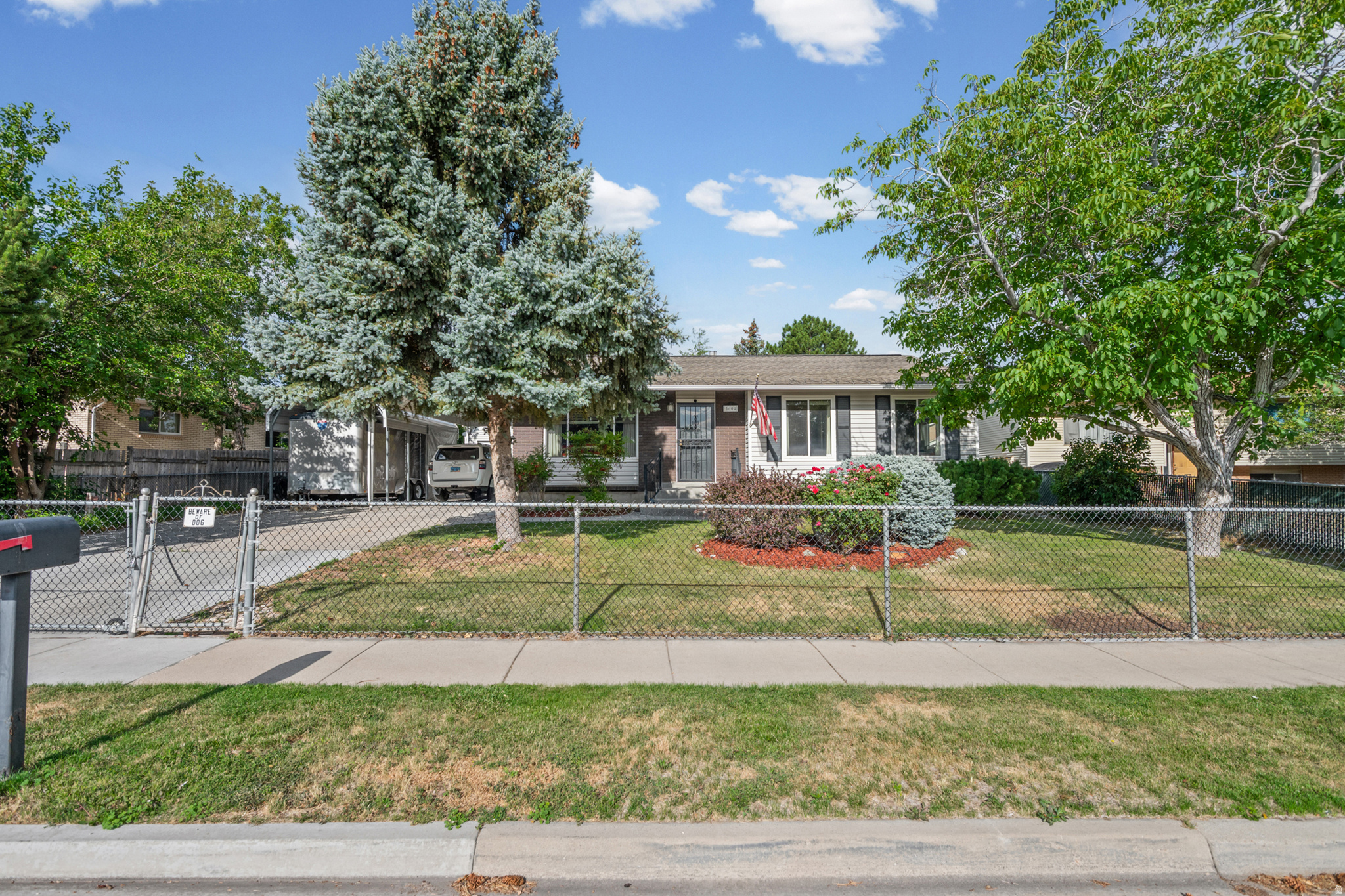 Welcome home! This well-maintained property is packed with upgrades and thoughtful features throughout. The updated kitchen offers modern style and functionality, while the oversized garage includes a workbench, 200-amp power service. Outside, you'll find two low-maintenance aluminum carports, RV parking, mature landscaping, automatic sprinklers, and a fully fenced yard that's perfect for pets, play, and outdoor entertaining. Additional upgrades include roof ice-melt wiring, a dedicated Christmas lighting outlet with timer, a whole-house surge protector, and a Generac backup generator that provides peace of mind during unexpected power outages. Energy-efficient improvements include added R-30 attic insulation and additional insulation in the exterior walls. The basement is already plumbed for a future kitchenette, offering excellent potential for a mother-in-law apartment or additional living space. This home offers a rare combination of comfort, functionality, and future possibilities. Schedule your private showing today! Square footage figures are provided as a courtesy estimate only and were obtained from county records. Buyer is advised to obtain an independent measurement. All information provided is deemed reliable but is not guaranteed and should be independently verified by buyer and buyer's agent.