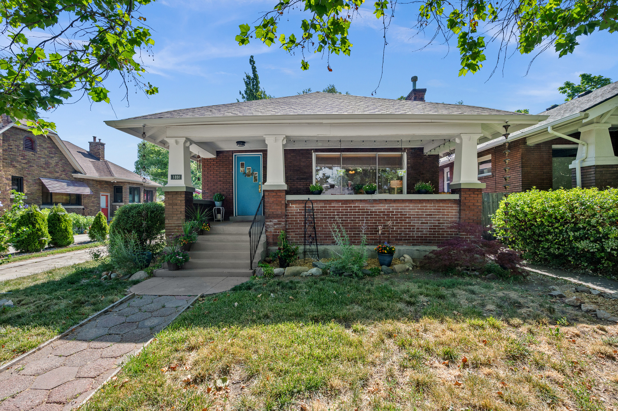 Classic Sugarhouse charm meets thoughtful updates in this inviting brick bungalow filled with timeless character. Original hardwood floors, abundant oversized windows, and a welcoming front porch create a warm first impression. Step inside to a spacious entryway, bright living room with a classic brick fireplace, and a large formal dining room featuring a beautiful south-facing bay window that fills the space with natural light. The functional floor plan offers two bedrooms plus a versatile bonus bedroom off the second bedroom-ideal as a nursery, home office, exercise room, playroom, or art studio. A convenient mudroom provides easy access from the backyard into the kitchen, adding everyday practicality. Recent updates include fresh paint in the living room, dining room, bathroom, and front porch, a new roof (2021), new furnace (2020), new central A/C (2024), new gutters and soffits (2024), plus updated water heater venting and expansion tank for added peace of mind. Enjoy relaxing summer evenings on the shady east-facing backyard patio overlooking a deep, tree-filled yard that feels like your own private forest. The oversized backyard offers plenty of room to add a future garage while still maintaining generous outdoor living space. The basement provides abundant storage for all your seasonal and recreational gear. Located in one of Salt Lake's most desirable neighborhoods, this charming bungalow offers the perfect blend of original character, modern updates, and easy access to all that Sugarhouse has to offer!  Square footage figures are provided as a courtesy estimate only.  Buyer is advised to obtain an independent measurement.