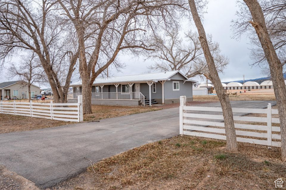 Create your own escape with this 4 bedroom home on a half an acre of land. Complete with the spacious covered front porch and white picket fence! A fifth room creates a nice area for an office. Zoned to allow second guest home for nightly/long term rental or mother-in-law quarters up to 800 sq. ft. Wood burning stove. Mature trees. RV parking. Large storage shed keeps things organized. There is a lot to love. Come see for yourself!