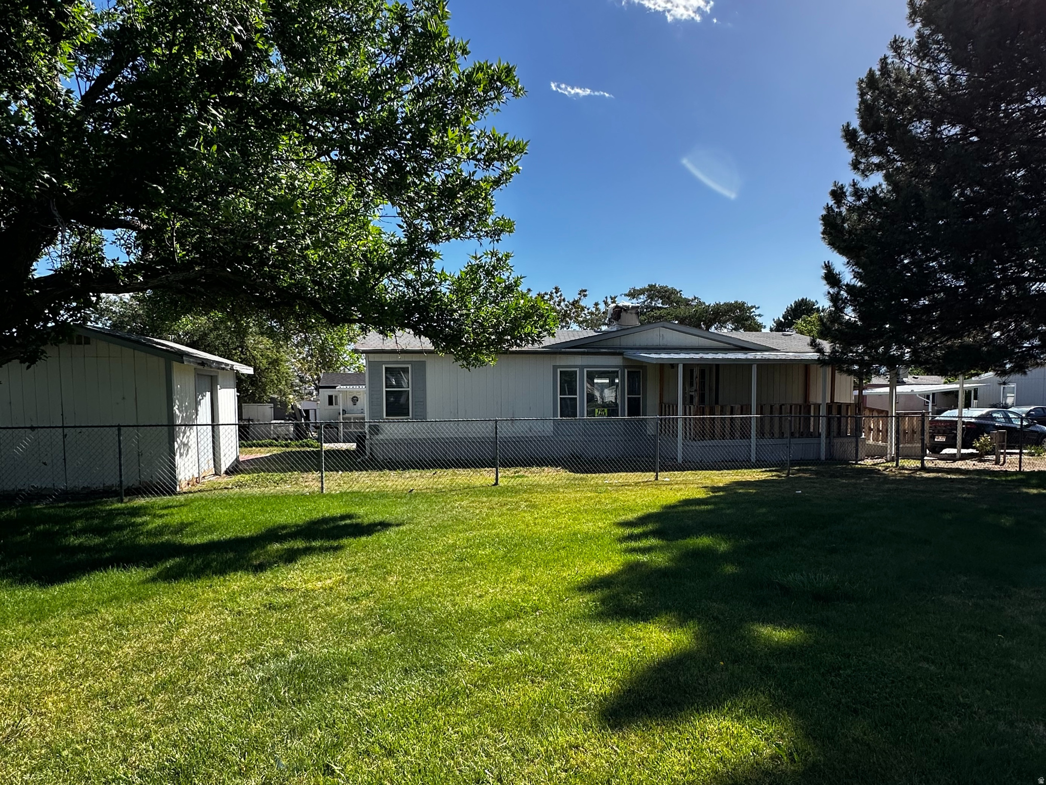 ANOTHER HUGE $10k PRICE REDUCTION!!!! SELLER IS MOTIVATED!!! Beautiful Open & spacious double-wide mobile home in a desirable Kearns park. It features an open floor plan with Cathedral Ceilings. 3 bedrooms and 2 bathrooms, including a large master bedroom, 2 rooms up front, and the Master in the back. New flooring through-out, while the kitchen offers plenty of space and cabinets. At just over 1,500 square feet of pure coziness, this home feels homey, yet spacious. Enjoy the front porch with no neighbors in front of you, perfect for relaxing among the trees and birds. The backyard includes 2 - storage sheds and covered porches in both the front and back. This home has a great open spacious layout - You do not want to miss seeing this home.  **Please remember, You must get Approved with the Park before submitting an offer** Square footage figures are provided as a courtesy estimate only and were obtained from County Records. Buyer is advised to obtain an independent measurement.