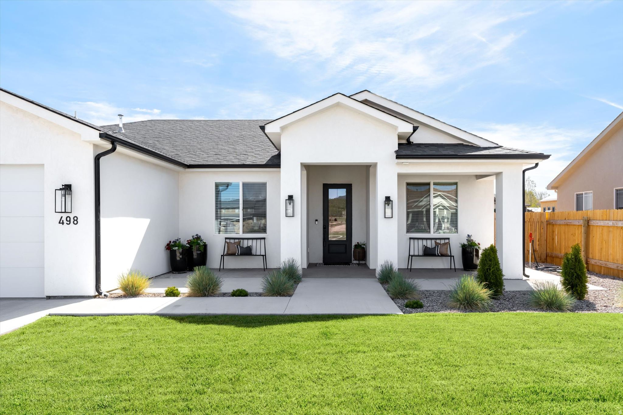 Set on a spacious .33 acre lot in Enterprise, this beautifully designed 5 bedroom, 2.5 bathroom home offers the perfect blend of comfort, functionality, and impressive extras. Thoughtfully laid out for both everyday living and entertaining, the open-concept great room flows seamlessly into the kitchen and dining area, creating a warm and inviting central gathering space.  The kitchen combines style and practicality with a large island, modern finishes, abundant cabinetry, and an oversized walk-in pantry that makes storage and organization effortless. A built-in study nook provides the ideal space for work, homework, or creative projects.  Privately situated, the primary suite serves as a relaxing retreat with a spacious bedroom, a beautifully appointed en suite featuring dual vanities and a soaking tub, and a large walk-in closet complete with custom-style storage. Four additional bedrooms offer flexibility for guests, hobbies, home offices, or growing needs while maintaining comfort and privacy throughout the home.  Step outside to enjoy year-round outdoor living with a covered patio, pergola, and fire pit area designed for relaxing evenings under the Southern Utah sky. The fully fenced backyard offers plenty of room to play, entertain, or create additional outdoor possibilities.  One of the property's standout features is the massive detached shop, providing exceptional space for vehicles, toys, hobbies, equipment, or a serious workshop setup. Combined with the oversized garage, the storage and workspace opportunities are truly hard to find.  With modern finishes, versatile living spaces, an oversized lot, and a peaceful Enterprise setting, this home delivers space, flexibility, and value in one outstanding package.